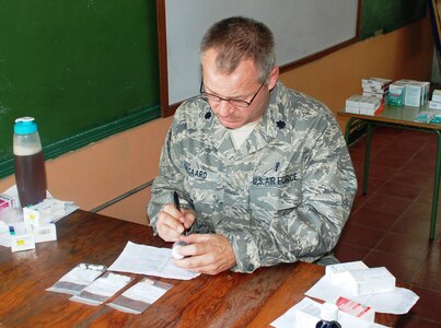 SOTO CANO AIR BASE, Honduras - Lt. Col. Douglas Odegard, Joint Task Force-Bravo Medical Element Ancillary Services officer, fills a perscription at a make-shift pharmacy in Choluteca Mar. 11.  Colonel Douglas was part of a Medical Readiness and Training Exercise held there to assist the Honduran Ministry of Health in providing basic medical services to residents of the area.  JTF-Bravo routinely conducts training exercises throughout Central Americal to ensure regional stability as well as to our ability to respond to natural disasters, provide humanitarian assistance, and protect the vital interests of the United States. (U.S. Air Force photo/Capt. John T. Stamm)