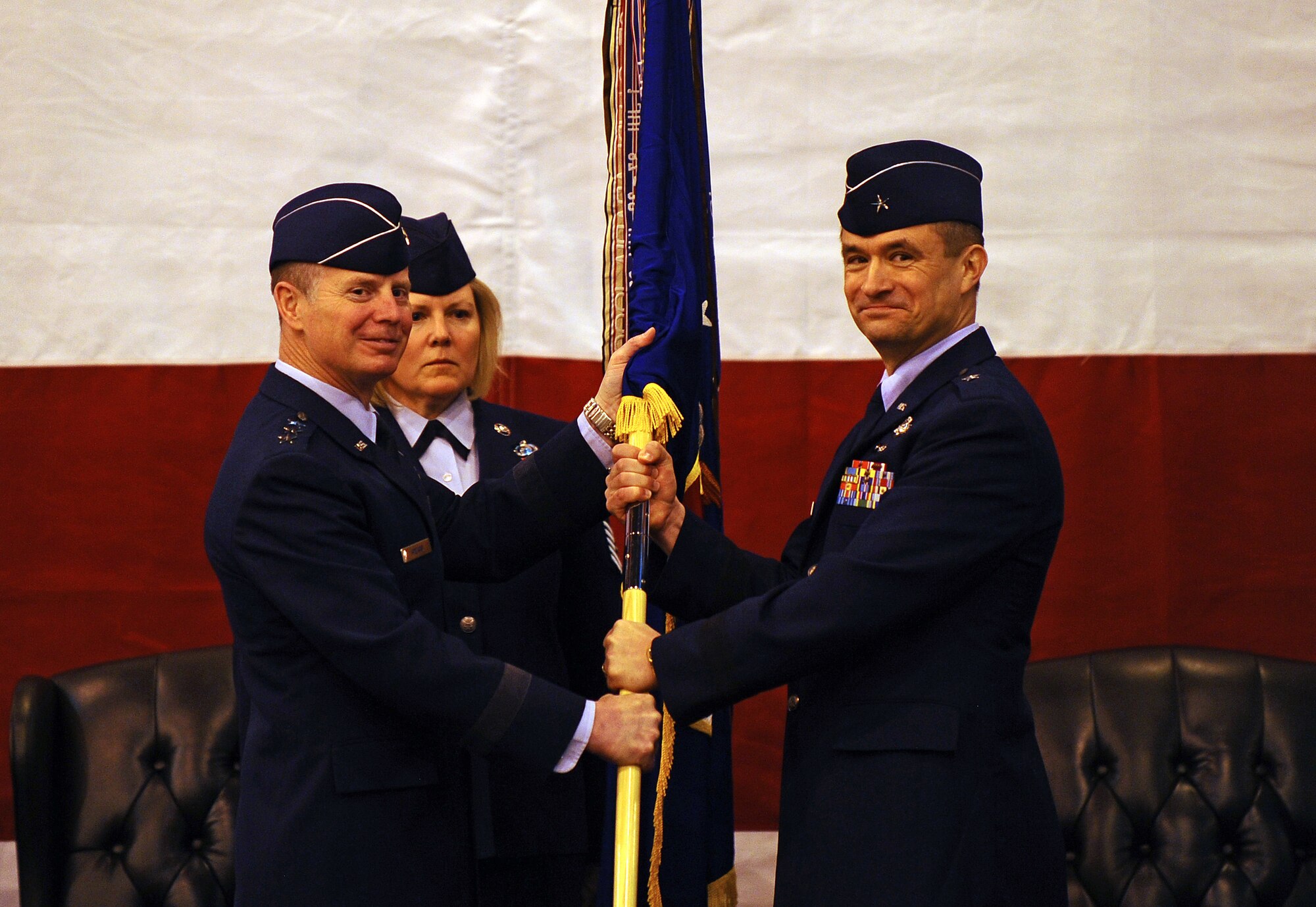 OFFUTT AIR FORCE BASE, Neb. - Lt. Gen. Glenn Spears, 12th AIr Force commander, hands the 55th Wing guidon to Brig. Gen. Donald Bacon, incoming 55th Wing commander, during a change of command ceremony March 9 at the Bennie Davis Maintenance Facility. General Bacon is already familiar with the 55th Wing, having served as commander of both the 41st Electronic Combat Squadron and the 55th Electronic Combat Group. U.S. Air Force photo by Josh Plueger (released)