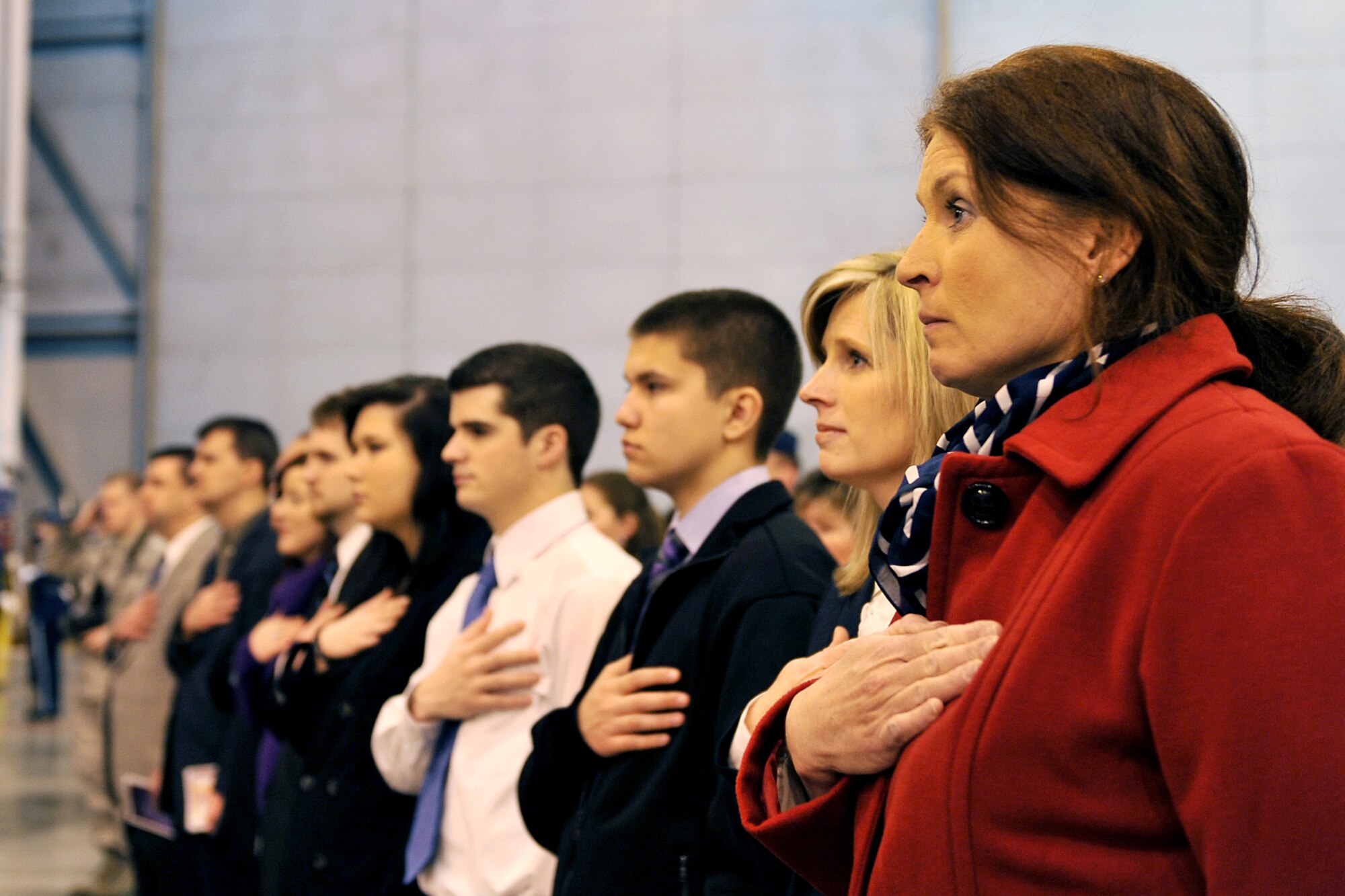 OFFUTT AIR FORCE BASE, Neb. - Laura Shanahan, wife of Brig. Gen. John N.T. Shanahan, outgoing 55th Wing commander, stands for the National Anthem during a change of command ceremony March 9 at the Bennie Davis Maintenance Facility. 
U.S. Air Force photo by Charles Haymond (released) 