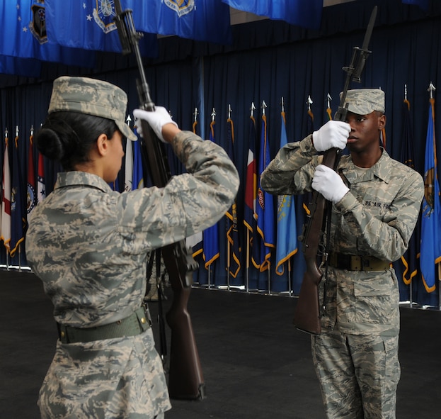 Airman Lucky Caswell III and Airman Amber Brown, trainees in The U.S. Air Force Honor Guard, critique each other while practicing drill movements March 11 at Joint Base Anacostia-Bolling, Washington, D.C. The eight-week USAF Honor Guard technical training school instills in the trainees the wingman concept, creating and reinforcing the wingman culture of airmen taking care of airmen. (U.S. Air Force photo by Senior Airman Christopher Ruano)
