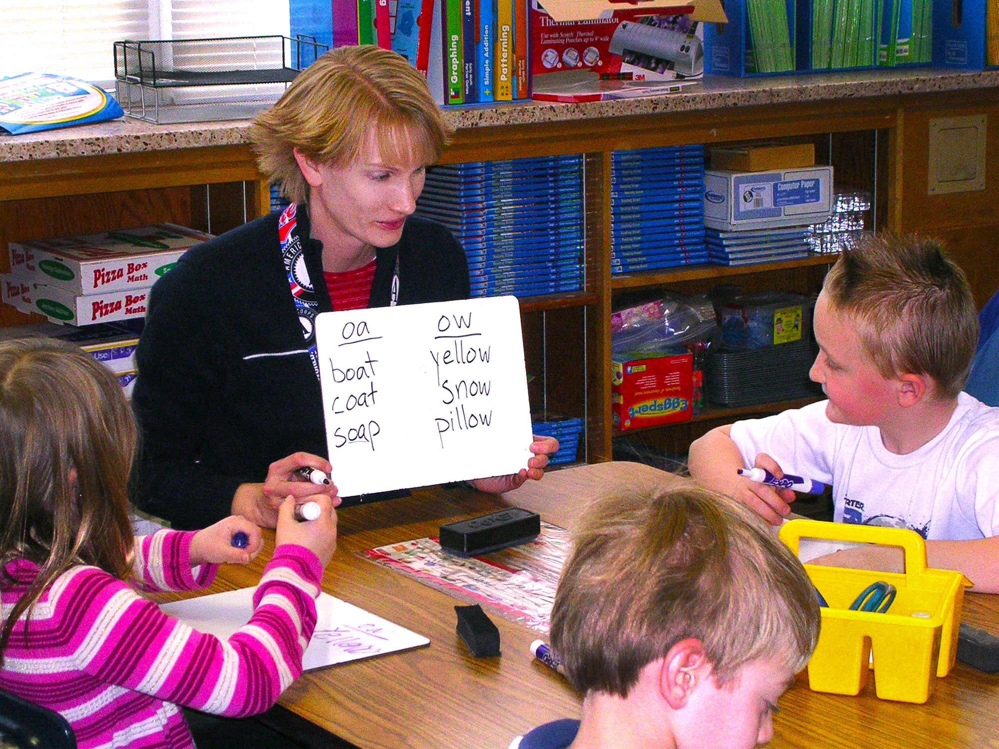Capt. Jill Stout, 419th Operations Group intelligence officer, volunteers at a local school tutoring children on how to read and write. (Courtesy photo)