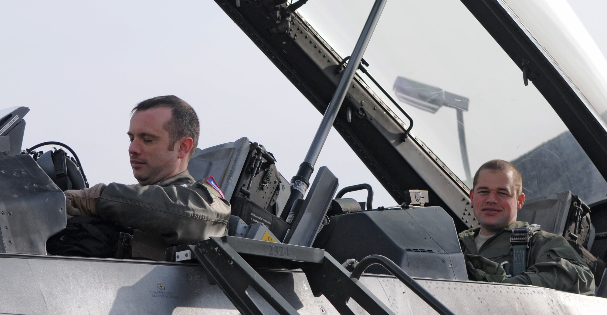 SPANGDAHLEM AIR BASE, Germany – Maj. Shaun Bellamy, 52nd Fighter Wing executive officer and F-16 Fighting Falcon pilot, and Staff Sgt. Asa McCurdy Jr., 703rd Munitions Support Squadron maintenance team chief, prepare to exit an F-16 after an incentive flight here March 10. Sergeant McCurdy went on an incentive flight for being the 2009 Lt. Gen. Leo Marquez Munitions Maintenance Technician/Supervisor for the Air Force. (U.S. Air Force photo/Airman 1st Class Matthew B. Fredericks)