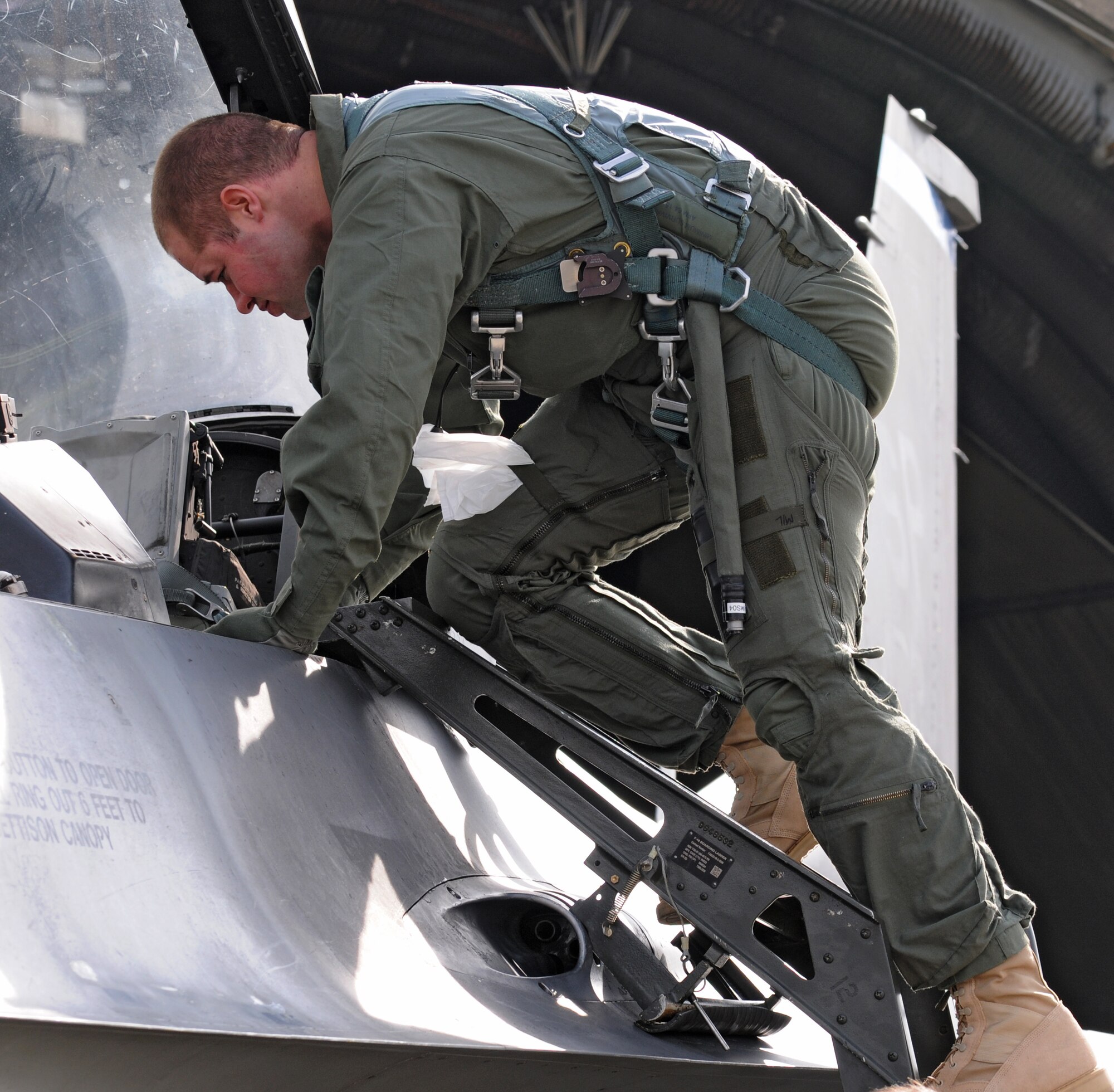 SPANGDAHLEM AIR BASE, Germany –Staff Sgt. Asa McCurdy Jr., 703rd Munitions Support Squadron maintenance team chief, exits an F-16 Fighting Falcon after an incentive flight here March 10. Sergeant McCurdy went on an incentive flight for being the 2009 Lt. Gen. Leo Marquez Munitions Maintenance Technician/Supervisor for the Air Force. (U.S. Air Force photo/Airman 1st Class Matthew B. Fredericks)