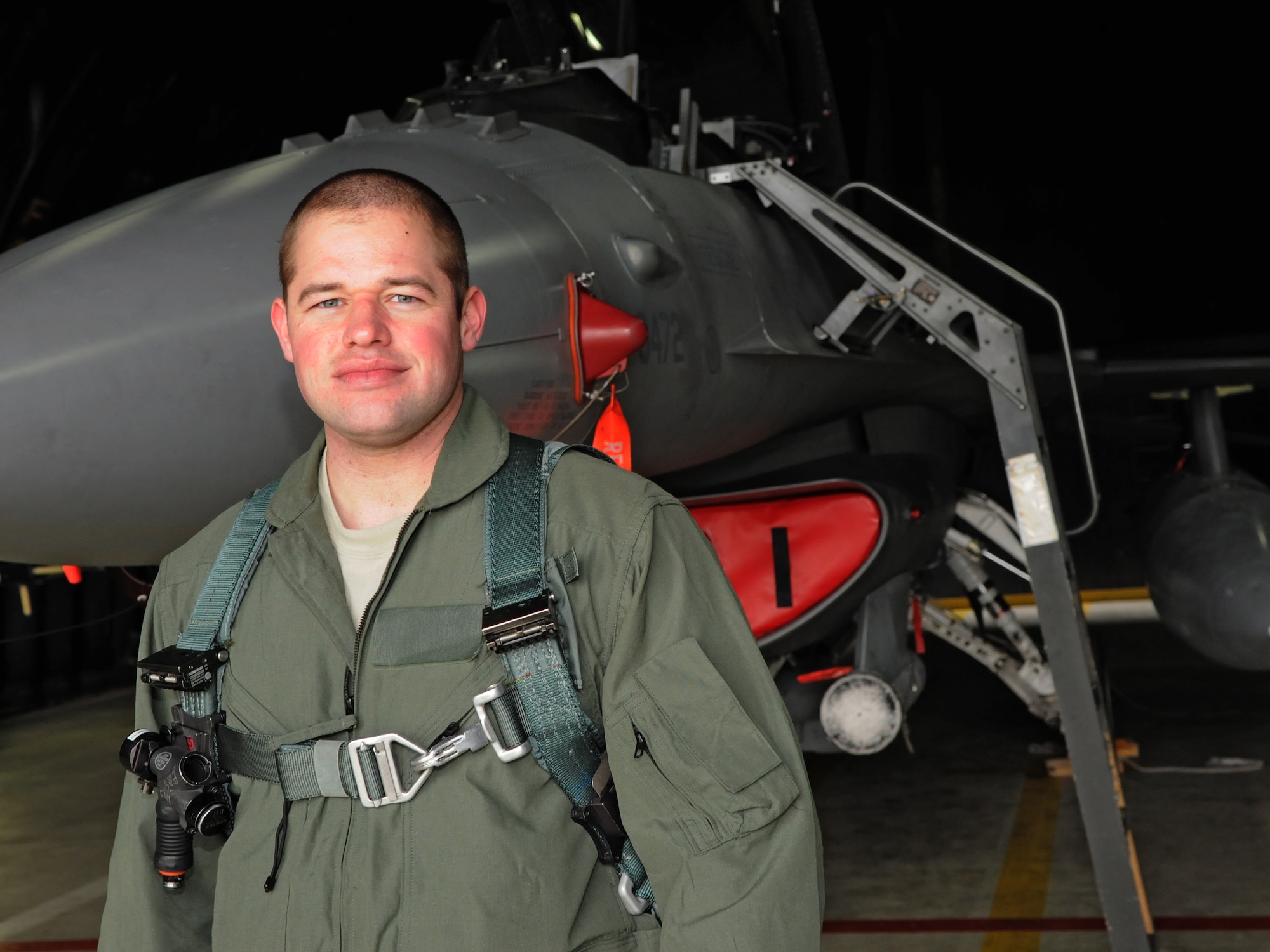 SPANGDAHLEM AIR BASE, Germany –Staff Sgt. Asa McCurdy Jr., 703rd Munitions Support Squadron maintenance team chief, stands in front of an F-16 Fighting Falcon after an incentive flight here March 10. Sergeant McCurdy went on an incentive flight for being the 2009 Lt. Gen. Leo Marquez Munitions Maintenance Technician/Supervisor for the Air Force. (U.S. Air Force photo/Airman 1st Class Matthew B. Fredericks)