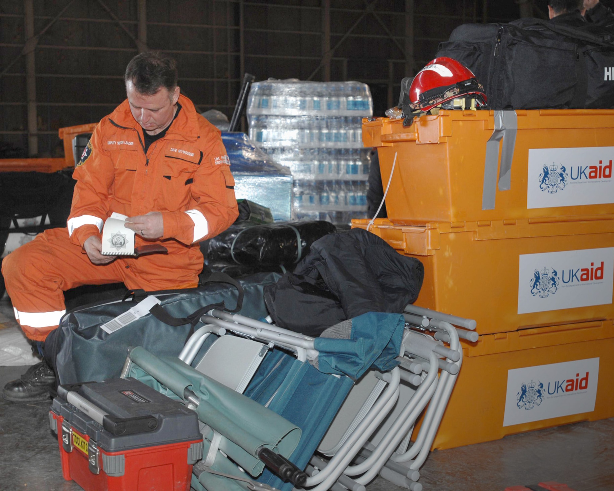 Dave Heybourne, a member of the United Kingdom International Search and Rescue team, preps his gear March 14, 2011, to support relief operations at Misawa Air Base, Japan, following an 8.9-magnitude earthquake that triggered a tsunami off Japan's eastern coast.  (U.S. Navy photo/Chief Petty Officer Daniel Sanford)