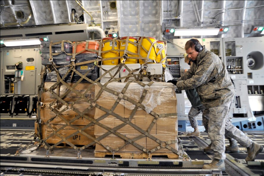 Airmen from the 89th Aerial Port Squadron load pallets onto a C-17 Globemaster III March 12, 2011, at Joint Base Andrews, Md. Air transportation Airmen prepared 14 pallets of technical search-and-rescue gear, including inflatable swift-water rescue boats, generators, trench rescue and cutting equipment. The gear is being transported by C-17 to provide assistance after an earthquake and tsunami hit Japan March 11, 2011. (U.S. Air Force photo/Senior Airman Perry Aston) 