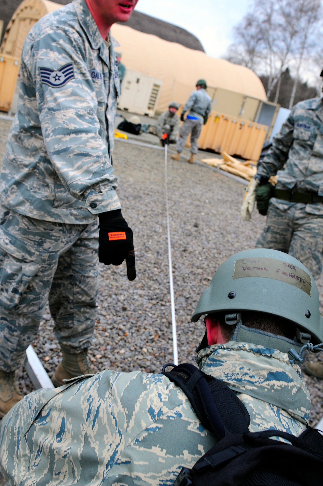 U.S. Air Force Airmen coordinate measurements for tent placement during the practical application exercise portion of Silver Flag, Ramstein Air Base, Germany, March 11, 2011. Silver Flag is a weeklong, training program that Airmen from all over the world participate in. Silver Flag combines classroom and practical application exercises to prepare airmen for deployment. (U.S. Air Force Photo by Airman 1st Class Brea Miller)