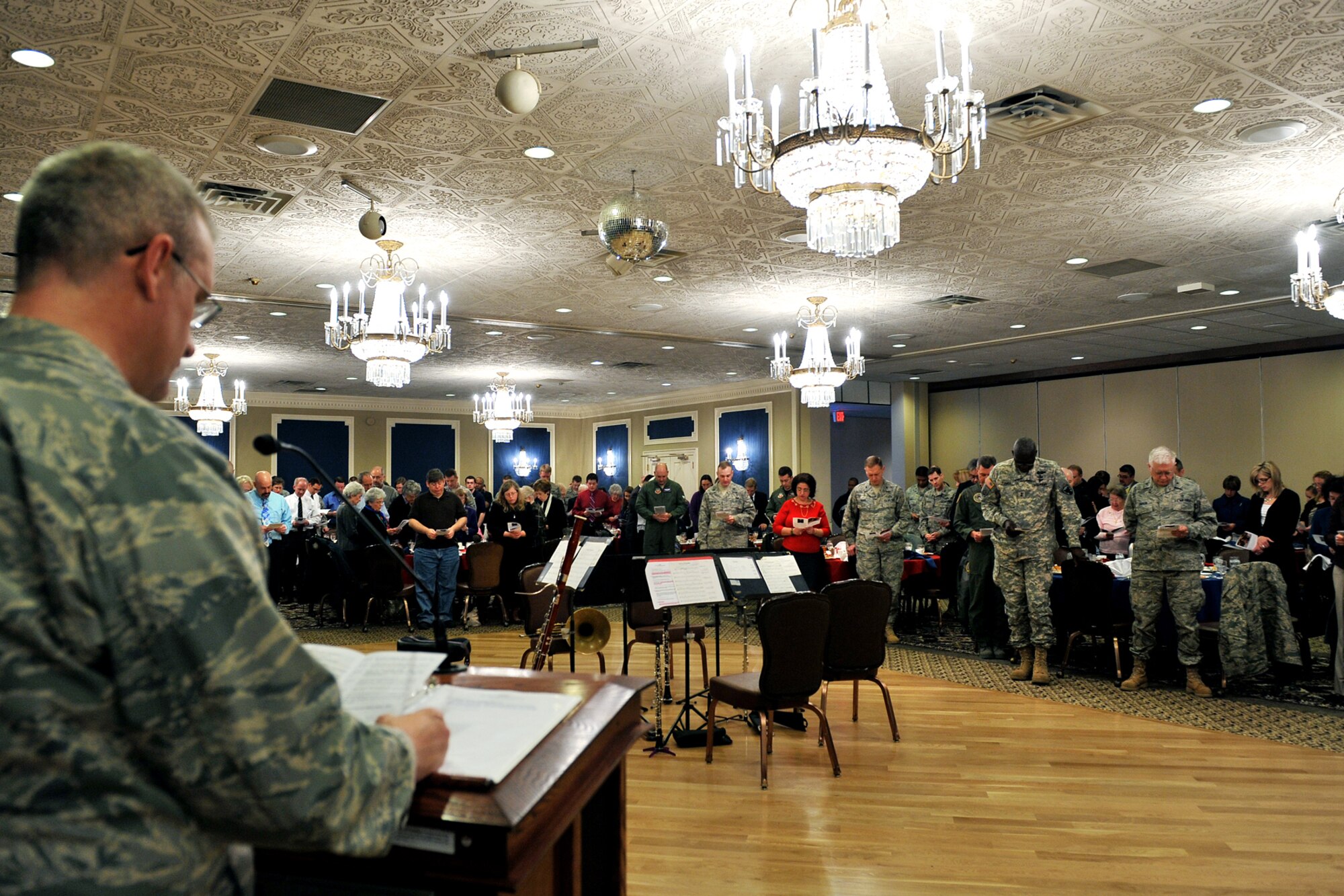 OFFUTT AIR FORCE BASE, Neb. - Capt. Robert Duplease, chaplain with the 55th Wing, leads Team Offutt members through the prayer for the nation during the national prayer luncheon inside the Patriot Club March 10. Throughout this luncheon many of Offutt's personnel representing different faiths and backgrounds came together to pray for warriors fighting for our nation and our families.  U.S. Air Force Photo by Charles Haymond