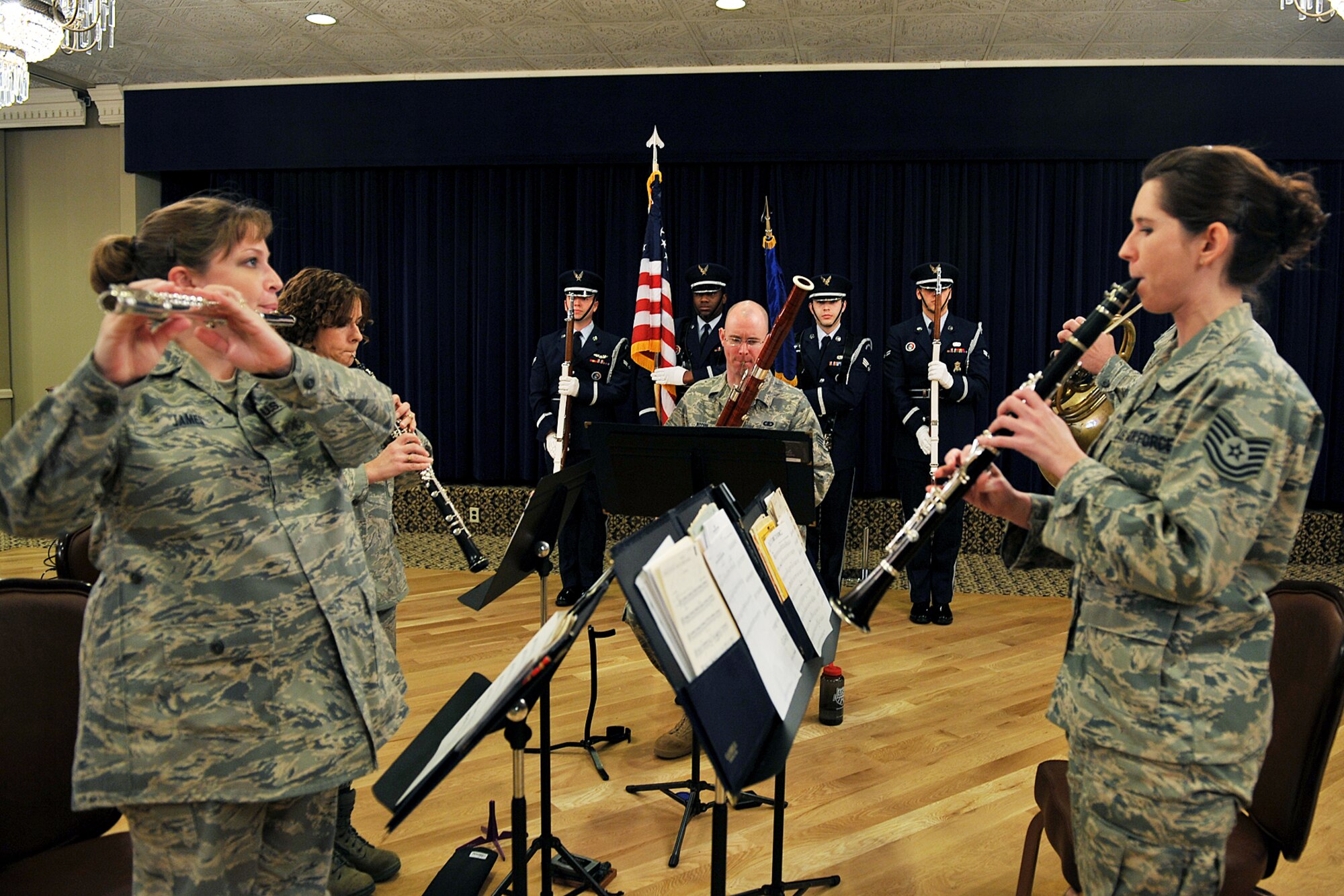 OFFUTT AIR FORCE BASE, Neb. - Heartland of America Band, Winds of Freedom, plays the National Anthem while members of the Offutt Air Force Base Honor Guard posts the colors during the national prayer luncheon inside the Patriot Club March 10. Throughout this luncheon many of Offutt's personnel representing different faiths and backgrounds came together to pray for warriors fighting for our nation and our families. U.S. Air Force Photo by Charles Haymond