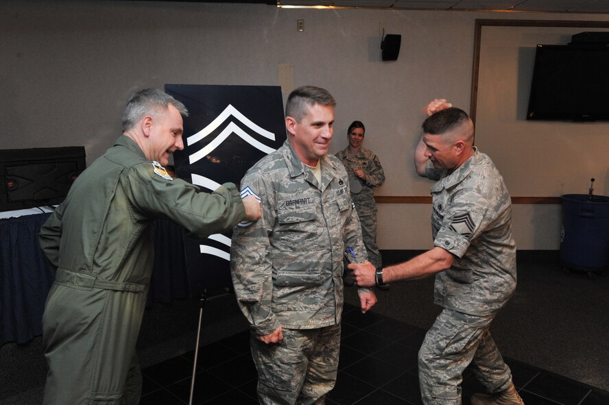 Col. Tim Fay, 2nd Bomb Wing commander, and Chief Master Sgt. Drew Baker, 2nd Maintenance Group Superintendent, tack on the rank of senior master sergeant to Master Sgt. Nathaniel Barnhart, 2MXG flight chief, during the Senior Master Sergeant Selection Ceremony at the Stripes Club on Barksdale Air Force Base, La., March 11. The ceremony recognizes those who will put on the rank of senior master sergeant this year. (U.S. Air Force photo Airman 1st Class Micaiah Anthony) (RELEASED)