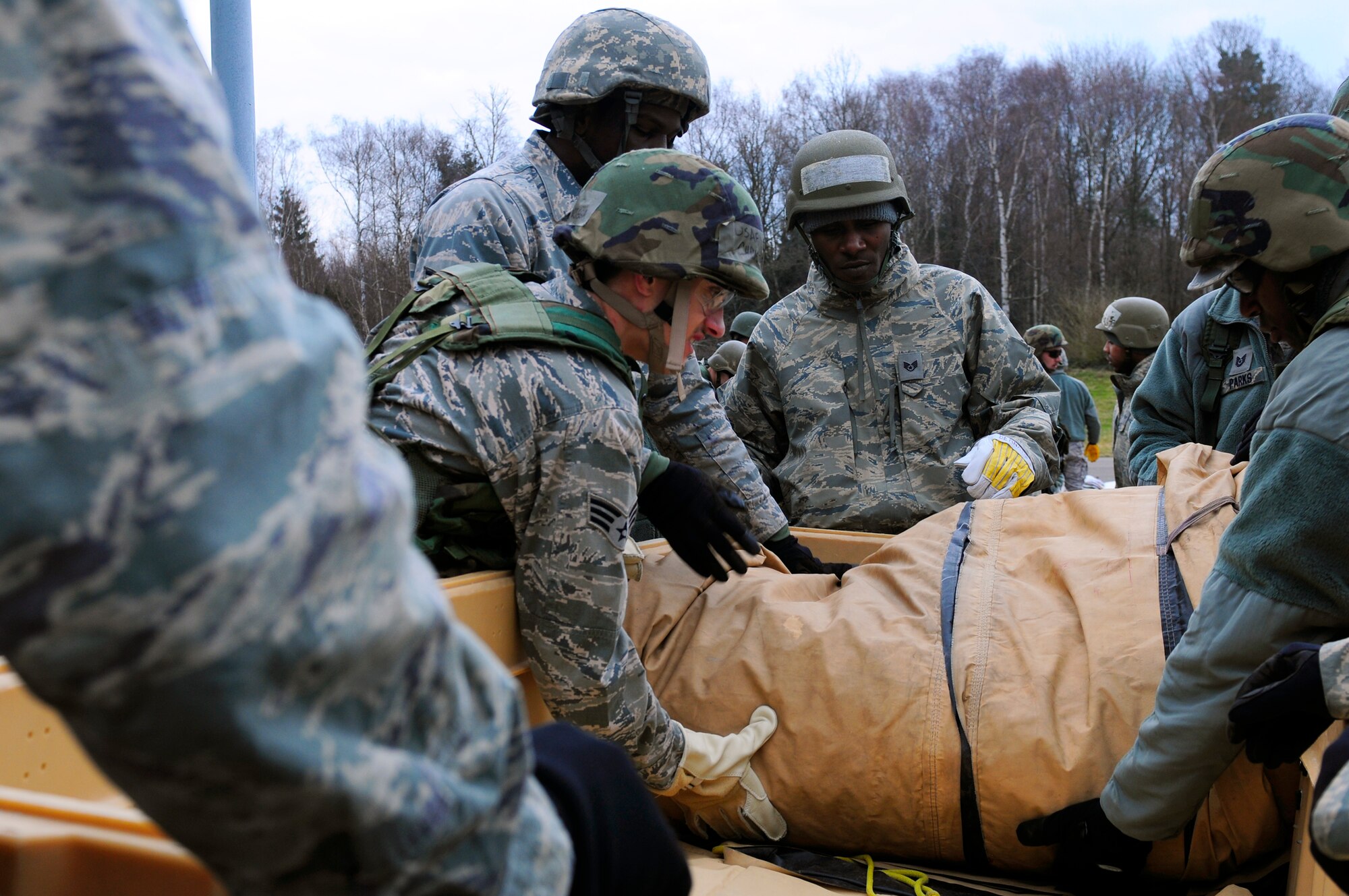 U.S. Air Force Airmen gather tent equipment before the practical application portion of Silver Flag, Ramstein Air Base, Germany, March 11, 2011. Silver Flag is a weeklong, training program that Airmen from all over the world participate in. Silver Flag combines classroom and practical application exercises to prepare airmen for deployment. (U.S. Air Force Photo by Airman 1st Class Brea Miller)