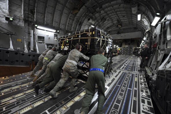 Airmen load a pallet onto a 62nd Airlift Wing C-17A Globemaster III on March 12, 2011, at March Air Reserve Base, Calif. The supplies are in route to Japan for earthquake relief efforts. (U.S. Air Force Photo/Staff Sgt. Matthew Smith) 