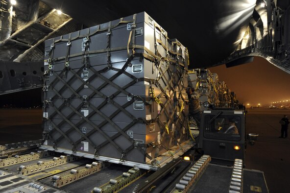 Airmen unload a pallet from a Tunner 60,000-pound capable loader on to a 62nd Airlift Wing C-17 Globemaster III on March 12, 2011, at March Air Reserve Base, Calif. The supplies are in route to Japan for earthquake relief efforts. (U.S. Air Force Photo/Staff Sgt. Matthew Smith) 