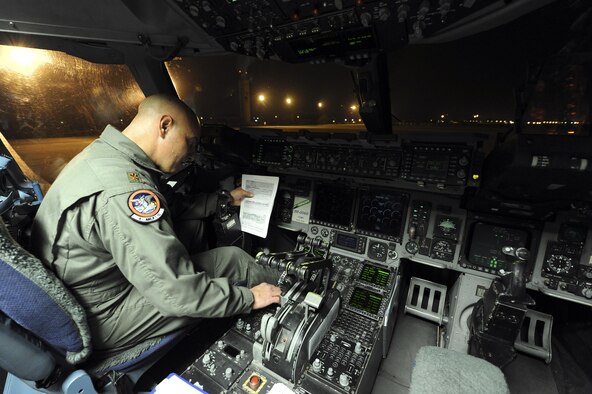 Maj. Todd Risk, 4th Airlift Squadron, Joint Base Lewis-McChord, Wash., inputs his flight plan into a 62nd Airlift Wing C-17 Globemaster III on March 12, 2011, at March Air Reserve Base, Calif., in preparation for a flight to Japan to help with earthquake relief. (U.S. Air Force Photo/Staff Sgt. Matthew Smith) 