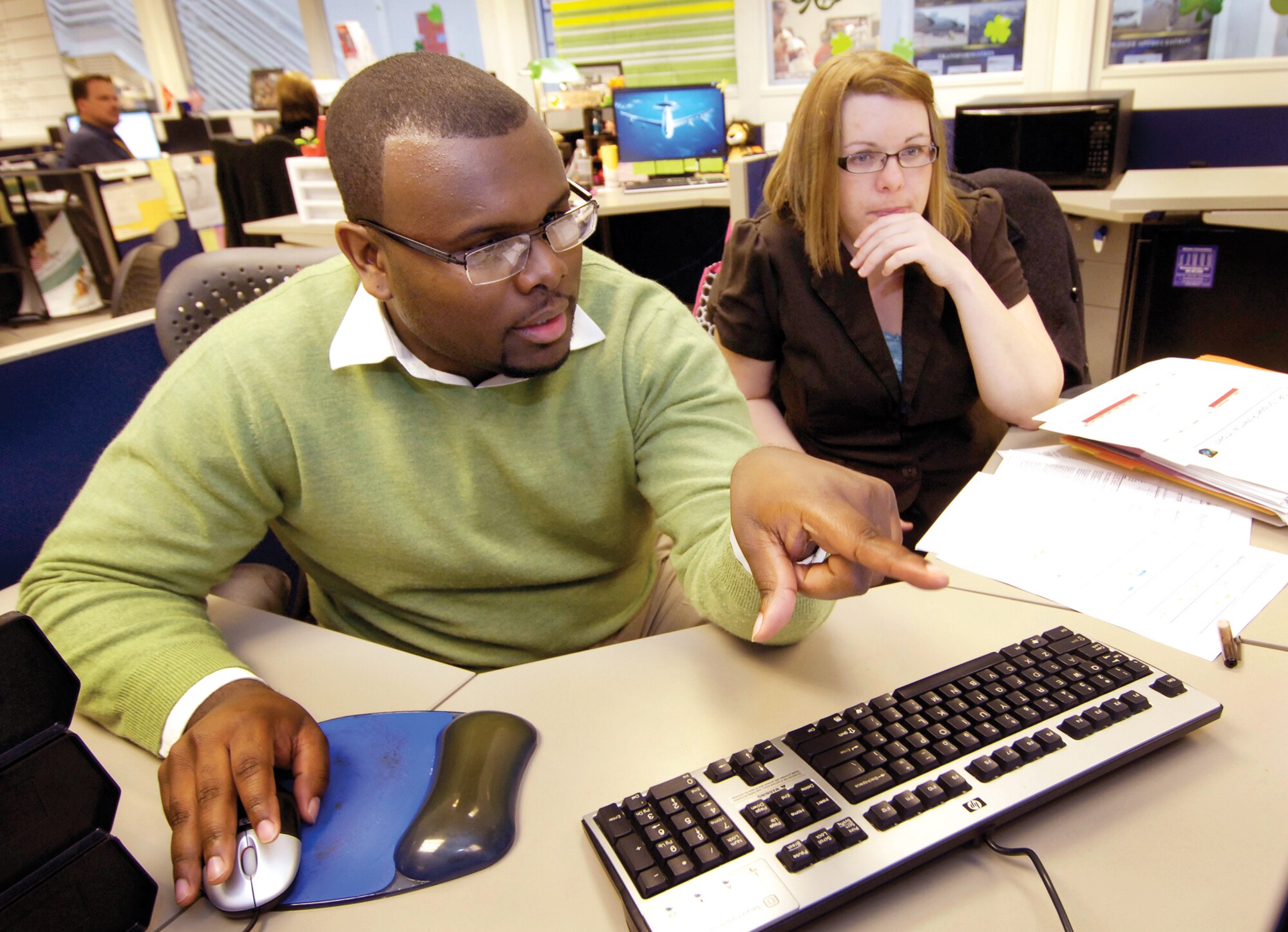 Kevin Gray and Michelle Blair focus on solving immediate problems of KC-135 parts needs in their roles as Depot Supply Chain Managers with the 848th Supply Chain Management Group. From their desks in the KC-135 Core Team area of Bldg. 3001, they prepare their bi-weekly updates for maintenance wing leadership.  (Air Force photo by Margo Wright)