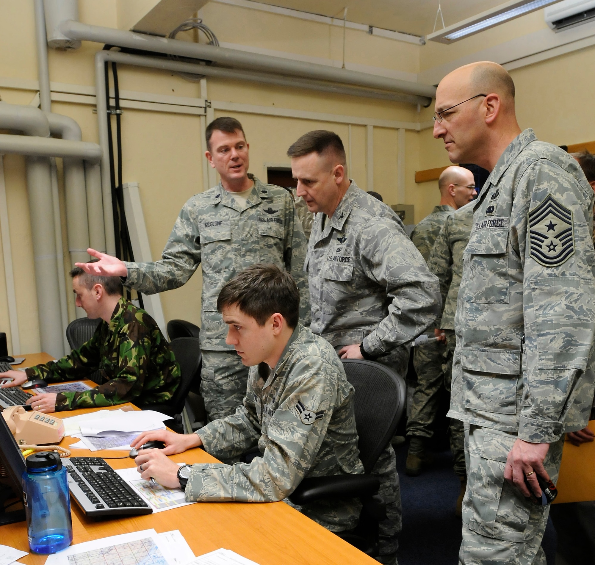 U.S. Air Force Col. Stephen Ling, 435th Air Ground Operations Wing vice commander, and Chief Master Sgt. Mitchell Stippel, 435th AGOW command chief, visit the 4th Air Support Operation Center to see how a new digital concept is being used during a joint exercise, Mannheim, Germany, March 10, 2011. The joint exercise is a pre-deployment preparation for both services to become familiar with equipment that they will be using while deployed. (U.S. Air Force photo by Airman Kendra Alba)