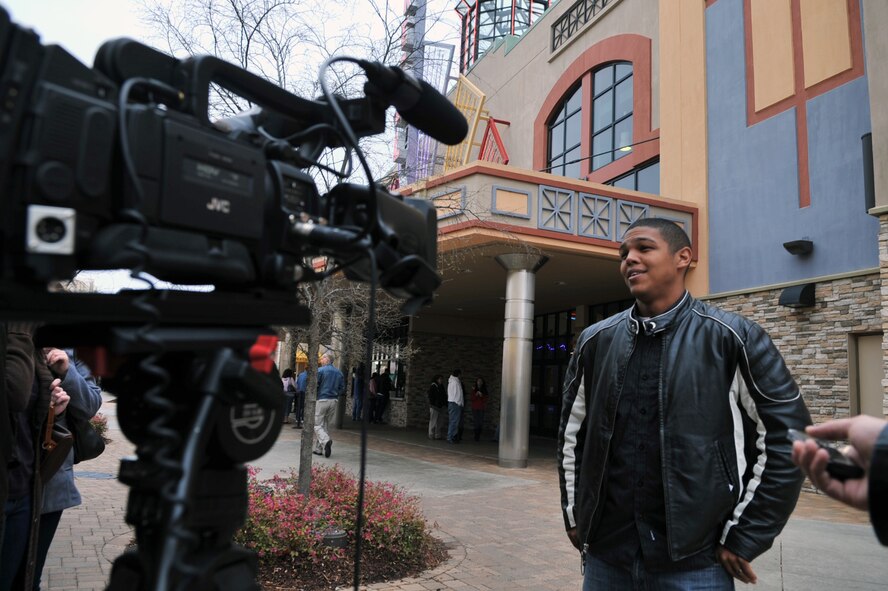 Staff Sgt. Michael Boutte, 2nd Security Forces Squadron, answers questions during an interview 2nd Bomb Wing Public Affairs about his role in the new film "Battle: Los Angeles" in front of the Regal Louisiana Boardwalk Stadium 14 in Bossier City, La., March 5. A portion of the movie was filmed on Barksdale Air Force Base and in the local Shreveport/Bossier area. The Airmen casted as extras were invited to an early screening courtesy of the Department of Defense Production Assistance Agreement and Sony. (U.S. Air Force photo/Airman 1st Class Micaiah Anthony)(RELEASED)