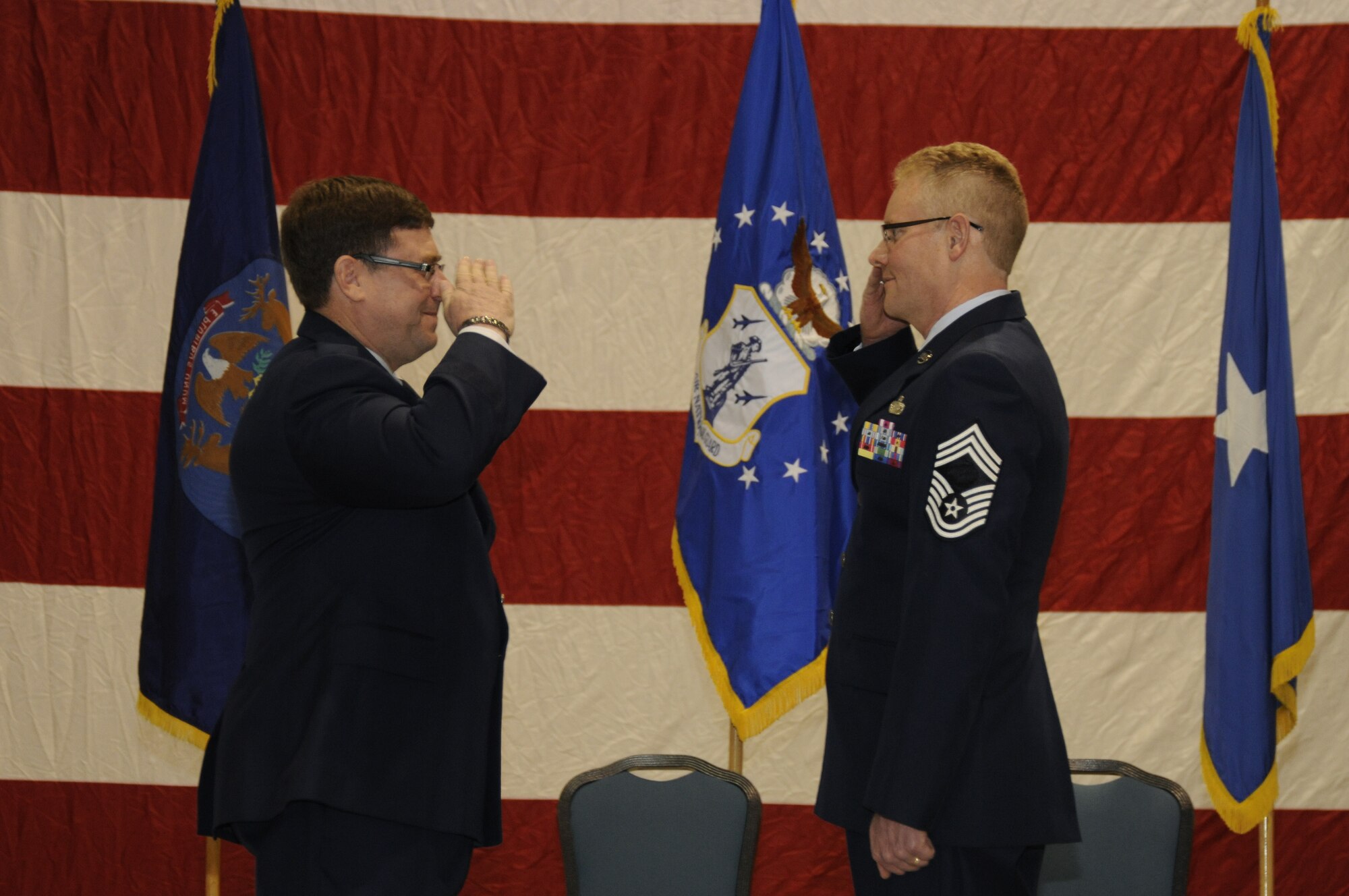 Brig. Gen. Michael Peplinski, commander, 127th Wing, returns the salute of Chief Master Sgt. Robert Dobson after Dobson formally assumes the role of command chief master sergeant of the 127th Wing, Selfridge Air National Guard Base, Mich., March 12, 2011. The command chief master sergeant serves as a special advisor to the commander on all matters that pertain to the enlisted force. Some 1,400 enlisted Airmen serve in the 127th Wing. (U.S. Air Force photo by TSgt. David Kujawa)(RELEASED)