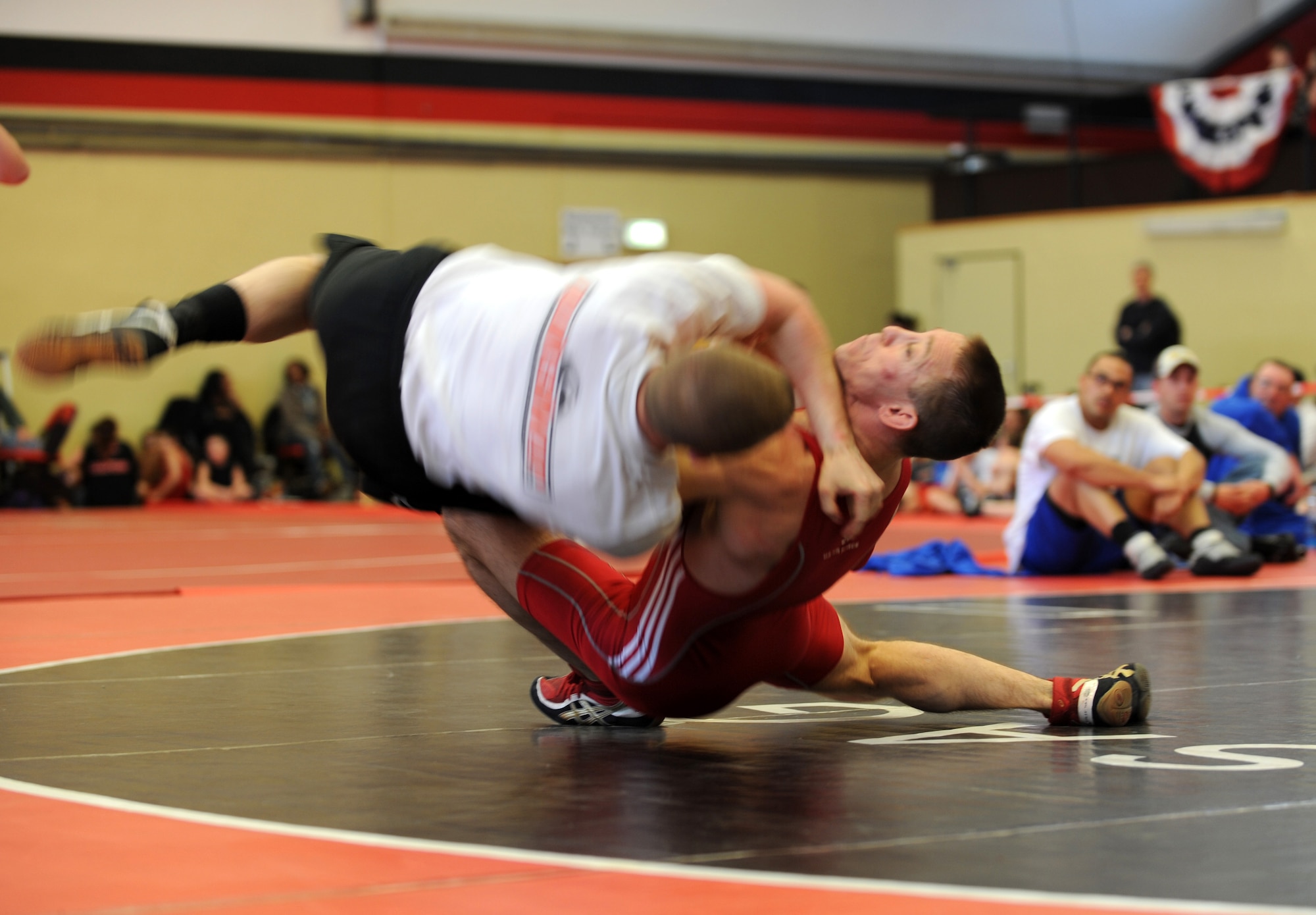 U.S. Air Force Master Sgt. Stephen Horton (Red), 86th Airlift Wing Public Affairs, wrestles Airman 1st Class Samuel Fulkerson, 786th Civil Engineer Squadron, both from Ramstein, in the Greco-Roman part of the U.S. Army Garrison Kaiserslautern invitational, Miesau Army Depot, Germany, March 12, 2011.  Sergeant Horton won first place and achieved the fastest pin time for Greco-Roman and Airman Fulkerson won third place in their weight division. Wrestlers from Ramstein, Aviano, K-town, Landstuhl Regional Medical Center, Baumholder, and Wiesbaden all took part in the invitational. Ramstein won the invitational with 102 points. (U.S. Air Force photo by Senior Airman Caleb Pierce)