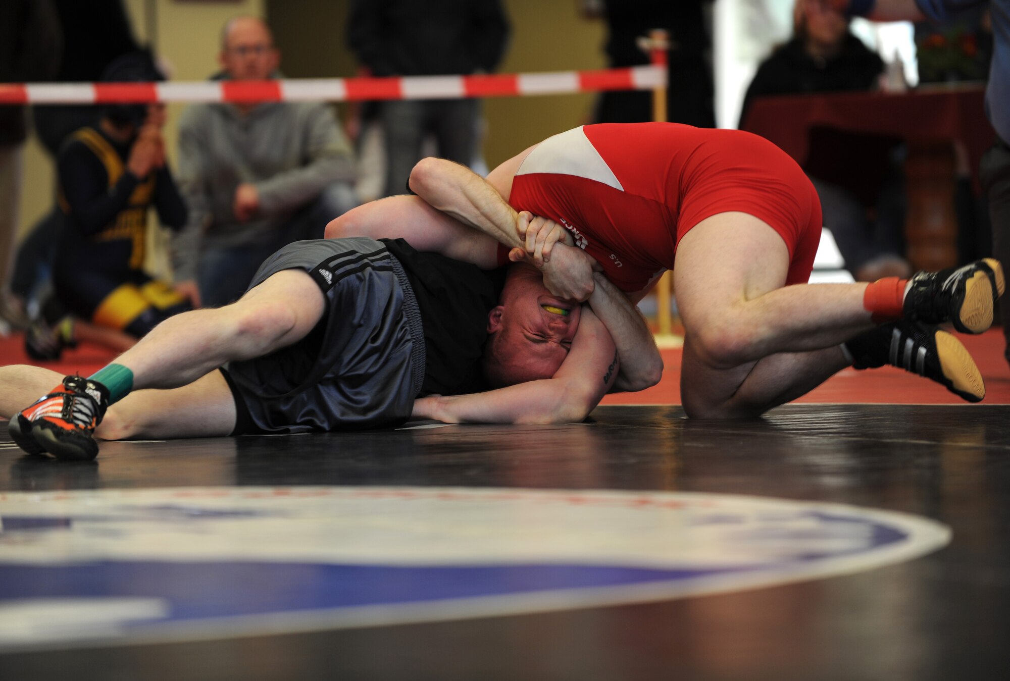 U.S. Air Force Senior Airman Philip Bean (Left), 86th Aircraft Maintenance Squadron, wrestles Airman 1st Class Christopher Reed, 86th Security Forces Squadron, in the Greco-Roman part of the U.S. Army Garrison Kaiserslautern invitational, Miesau Army Depot, Germany, March 12, 2011.  Both Airmen are from Ramstein AB.  Airman Reed won second place for Greco-Roman in his weight division. Wrestlers from Ramstein, Aviano, K-town, Landstuhl Regional Medical Center, Baumholder, and Wiesbaden all took part in the invitational. Ramstein won the invitational with 102 points. (U.S. Air Force photo by Senior Airman Caleb Pierce)