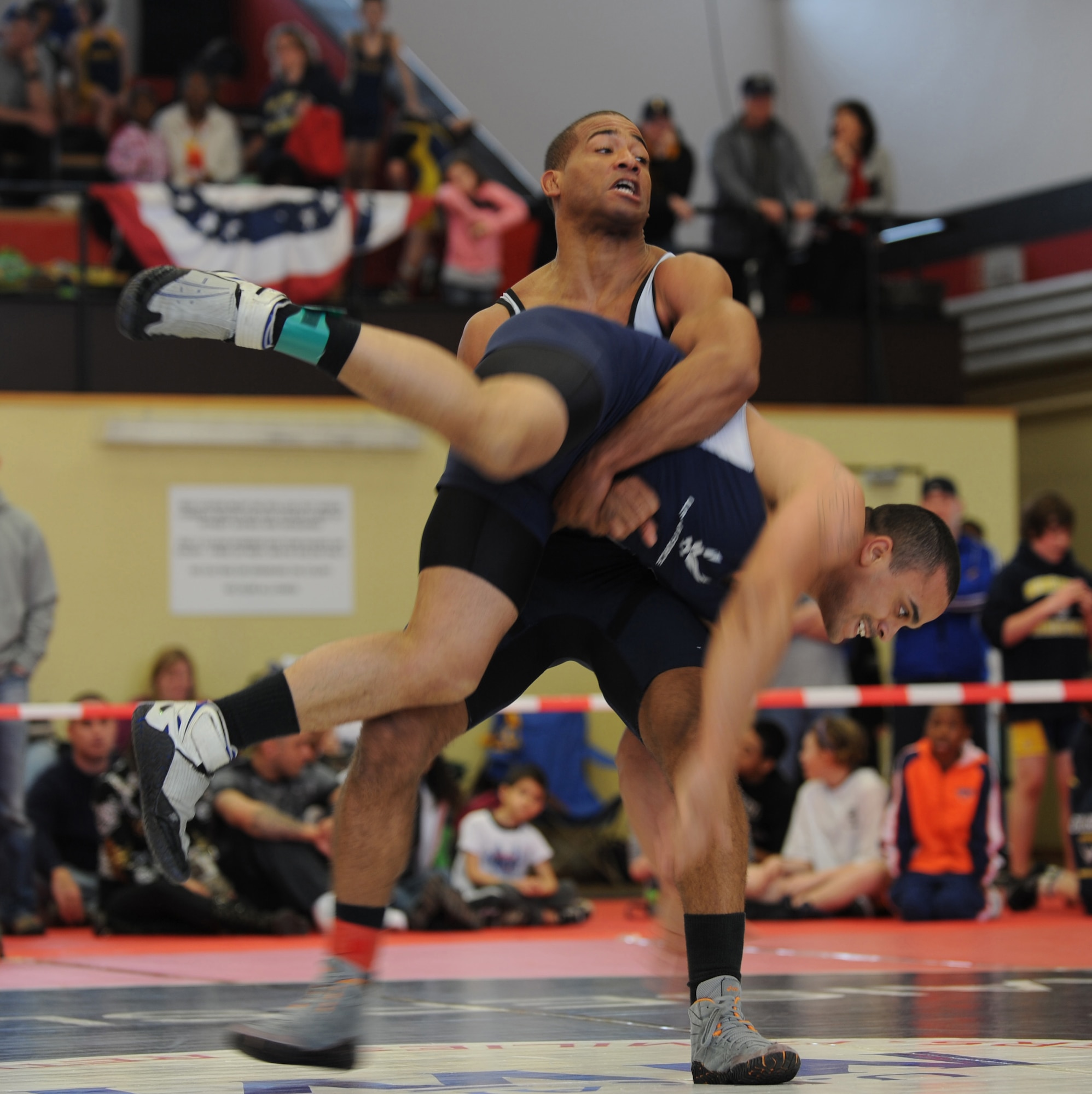 U.S. Air Force Tech Sgt. Sherwin Severin (Top), 31st Security Forces Squadron from Aviano, wrestles Airman 1st Class Steven Chamble, 886th Civil Engineer Squadron from Ramstein, in the Greco-Roman part of the U.S. Army Garrison Kaiserslautern invitational, Miesau Army Depot, Germany, March 12, 2011.  Sergeant Severin won first place for Greco-Roman in his weight division and most outstanding wrestler for Greco-Roman. Wrestlers from Ramstein, Aviano, K-town, Landstuhl Regional Medical Center, Baumholder, and Wiesbaden all took part in the invitational. Ramstein won the invitational with 102 points. (U.S. Air Force photo by Senior Airman Caleb Pierce)