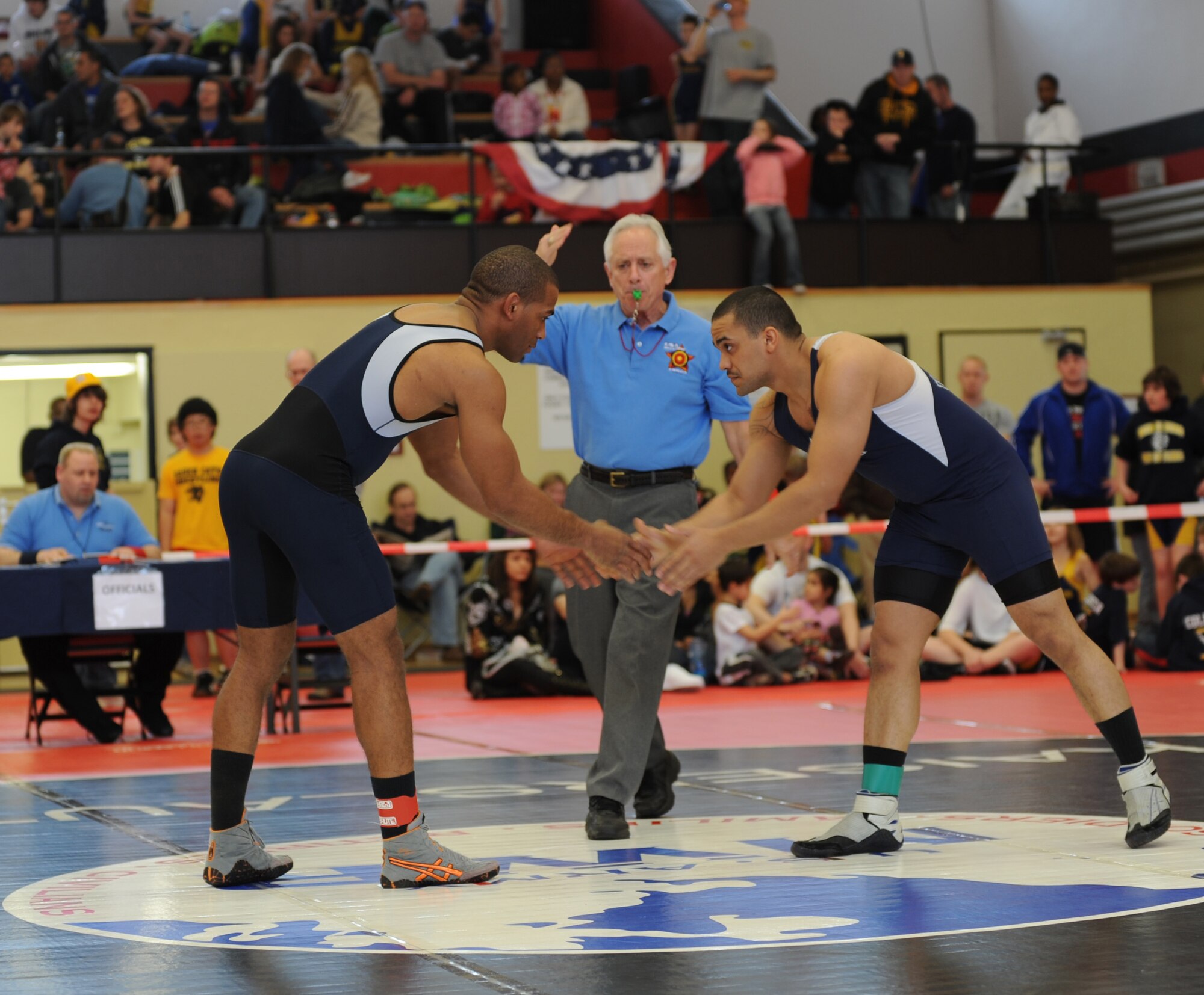 U.S. Air Force Tech Sgt. Sherwin Severin (Left), 31st Security Forces Squadron from Aviano, wrestles Airman 1st Class Steven Chamble, 886th Civil Engineer Squadron from Ramstein, in the Greco-Roman part of the U.S. Army Garrison Kaiserslautern invitational, Miesau Army Depot, Germany, March 12, 2011.  Sergeant Severin won first place for Greco-Roman in his weight division and most outstanding wrestler for Greco-Roman.  Wrestlers from Ramstein, Aviano, K-town, Landstuhl Regional Medical Center, Baumholder, and Wiesbaden all took part in the invitational. Ramstein won the invitational with 102 points. (U.S. Air Force photo by Senior Airman Caleb Pierce)