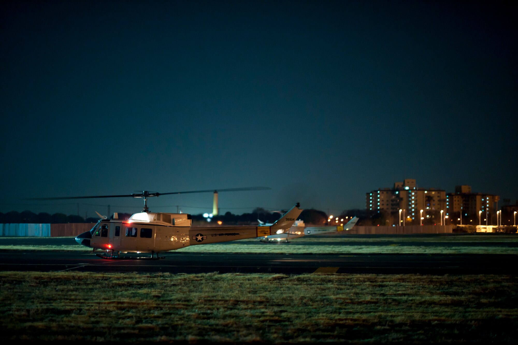 YOKOTA AIR BASE, Japan -- Two UH-1N Iroquois helicopters land here after transporting search and rescue members to Kasuminome Airfield March 13. UH-1N helicopters at Yokota Air Base normally provide base leadership fast and efficient means of transit to meetings and events in downtown Tokyo, but are currently being used to shuttle disaster relief personnel to locations along Japan’s East Coast. (U.S. Air Force photo/Staff Sgt. Samuel Morse) 