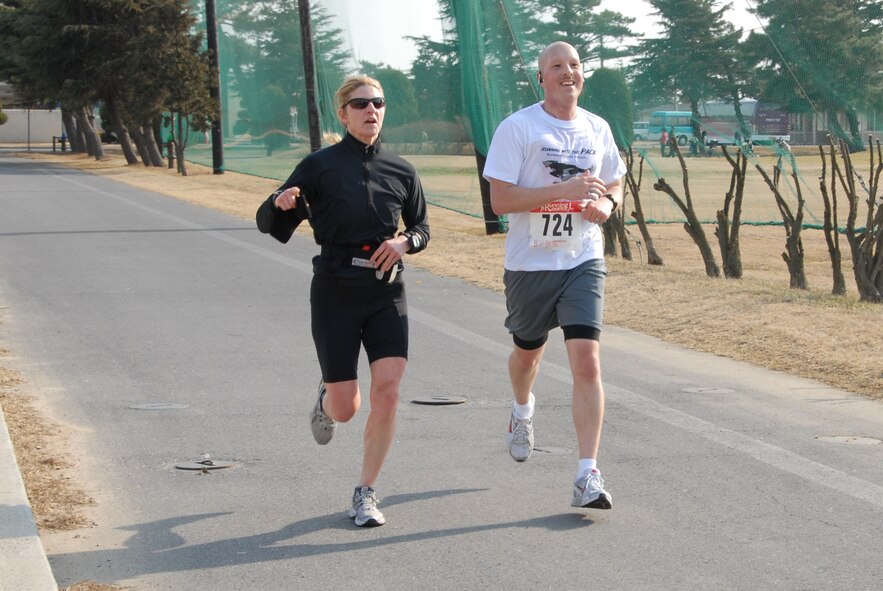 KUNSAN AIR BASE, Republic of Korea -- Lt. Col. Mical Kupke and Tech. Sgt. Matthew Hardy, 8th Medical Group, complete the Kunsan half-marathon March 11. Colonel Kupke was the female aged 40 and over winner with a time of 1:57:40. (U.S. Air Force/Staff Sgt. Amanda Savannah)