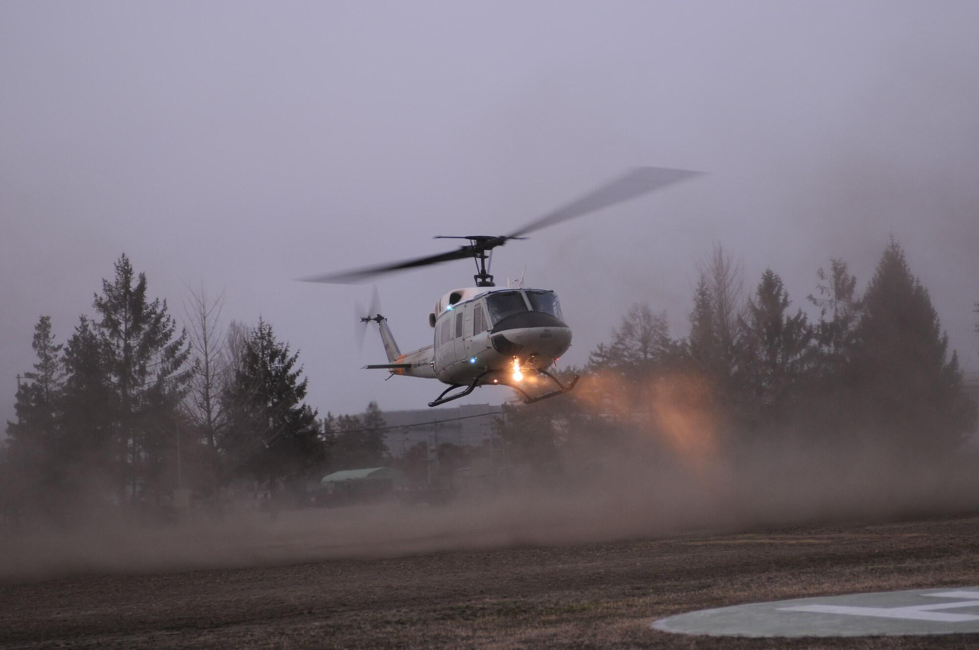 KASUMINOME AIRFIELD, Japan -- A UH-1N Iroquois helicopter drops off search and rescue members at Kasuminome Airfield March 13. UH-1N helicopters at Yokota Air Base normally provide base leadership fast and efficient means of transit to meetings and events in downtown Tokyo, but are currently being used to shuttle disaster relief personnel to locations along Japan’s East Coast. (U.S. Air Force photo/Airman 1st Class Krystal M. Garrett) 

