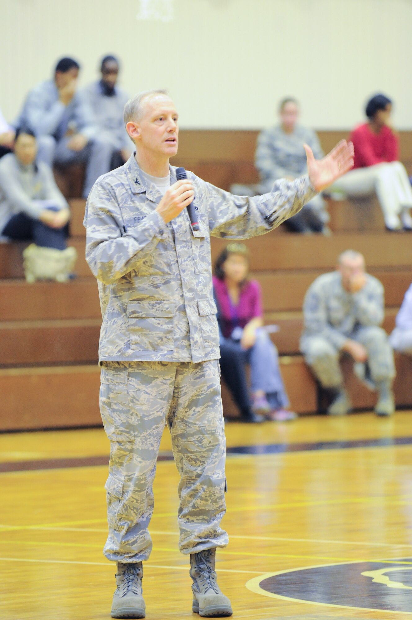 YOKOTA AIR BASE, Japan -- Col. Otto Feather, 374th Airlift Wing commander, answers questions during a Town Hall meeting Monday at the base fitness center. The commander called the meeting to address community concerns and provide information on how services may be effected by relief efforts. (U.S. Air Force photo/Airman 1st Class Krystal M. Garrett)