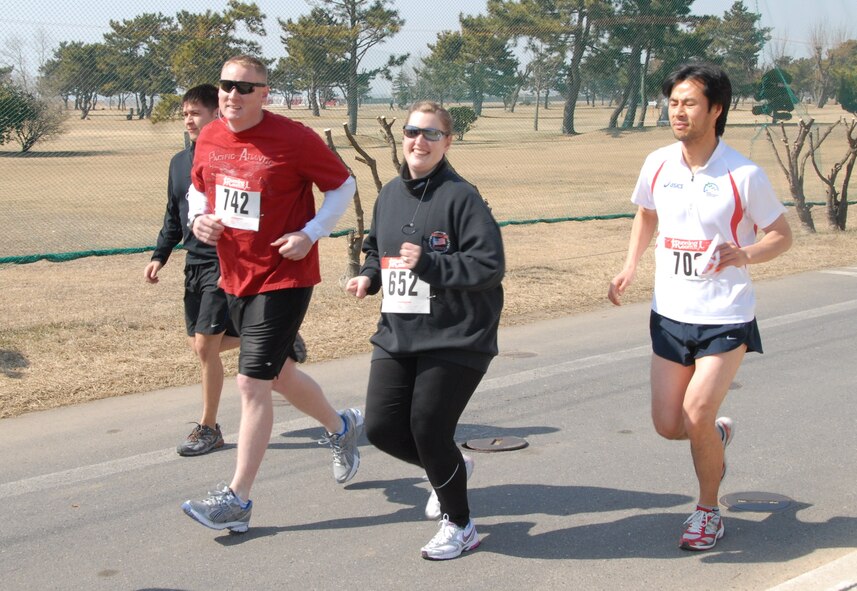 KUNSAN AIR BASE, Republic of Korea -- Master Sgt. Carolyn Urdiales, 8th Fighter Wing commander's knowlege operations management superintendent, and her running partner Master Sgt. Sonny Cohrs, 8th FW public affairs superintendent, start the Kunsan half-marathon strong March 11. This was the first time Sergeant Urdiales participated in any long-distance running event. (U.S. Air Force/Staff Sgt. Amanda Savannah)