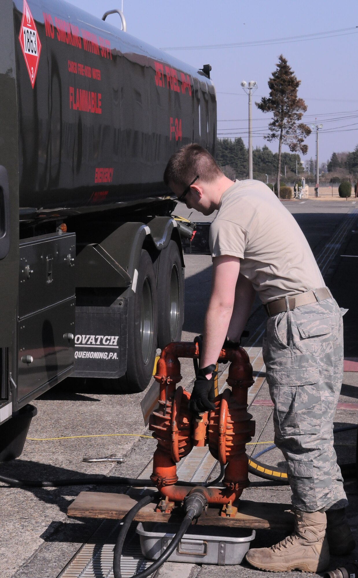 YOKOTA AIR BASE, Japan -- Airman Basic Dustin Hammond, 374th Logistics Readiness Squadron refueling maintenance technician, prepares to empty an R-11 fuel truck here, March 13. The fuel trucks were checked and prepared for transit to support forward aircraft providing relief to Japanese citizens affected by the earthquake and tsunami on the east coast of Japan, on March 11. (U.S. Air Force photo/Airman 1st Class Krystal M. Garrett)