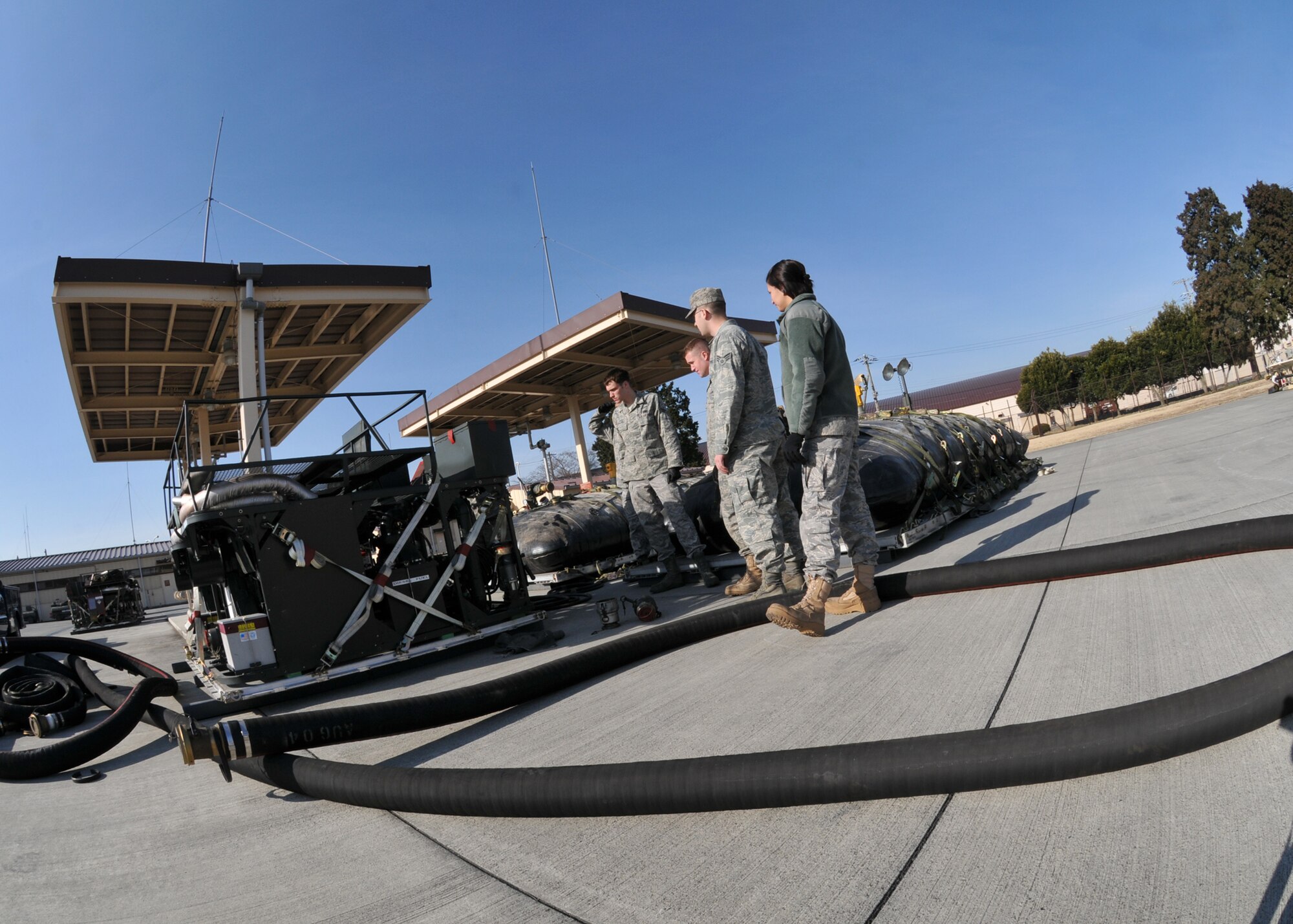 YOKOTA AIR BASE, Japan -- Airmen from the 374th Logistics Readiness Squadron petroleum, oils and lubricants flight fill a fuel bladder here, on March 14. The fuel bladders were checked and prepared for transit to support forward aircraft providing relief to Japanese citizens affected by the earthquake and tsunami on the east coast of Japan, on March 11. (U.S. Air Force photo/Airman 1st Class Andrea Salazar)