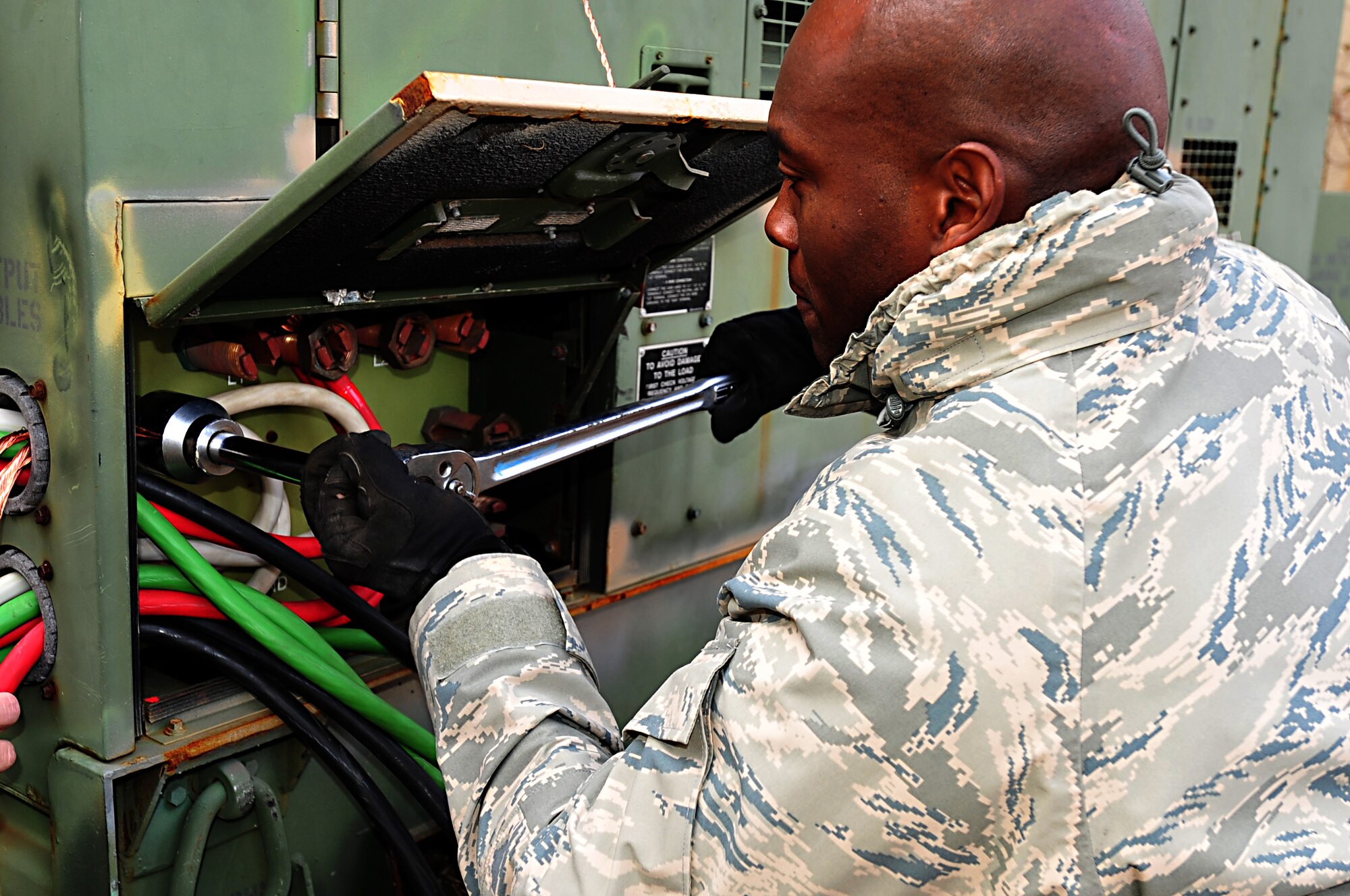 MISAWA AIR BASE, Japan -- U.S. Air Force Tech. Sgt. Danny Dottin, 18th Civil Engineer Squadron generator maintenance shop, connects power cables to a generator located at the Misawa Inn Mar. 14. Members of the 18 CES came to assist with recovery operations. U.S. Air Force photo by Staff Sgt. Marie Brown\Released)