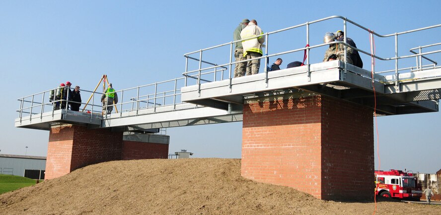 RAF MILDENHALL, England -- The confined space trainer, which is a brand new facility, gives firefighters the ability to ascend and descend if the main steps are out of action, using a special tripod and mechanical hauling system. It also allows firefighters to build creative ways of reaching a victim when all assets are still on the ground. Other units can also use the trainer, including other 100th CES flights, the 100th Communications Squadron and 352nd Special Operations Group. (U.S. Air Force photo/Karen Abeyasekere)