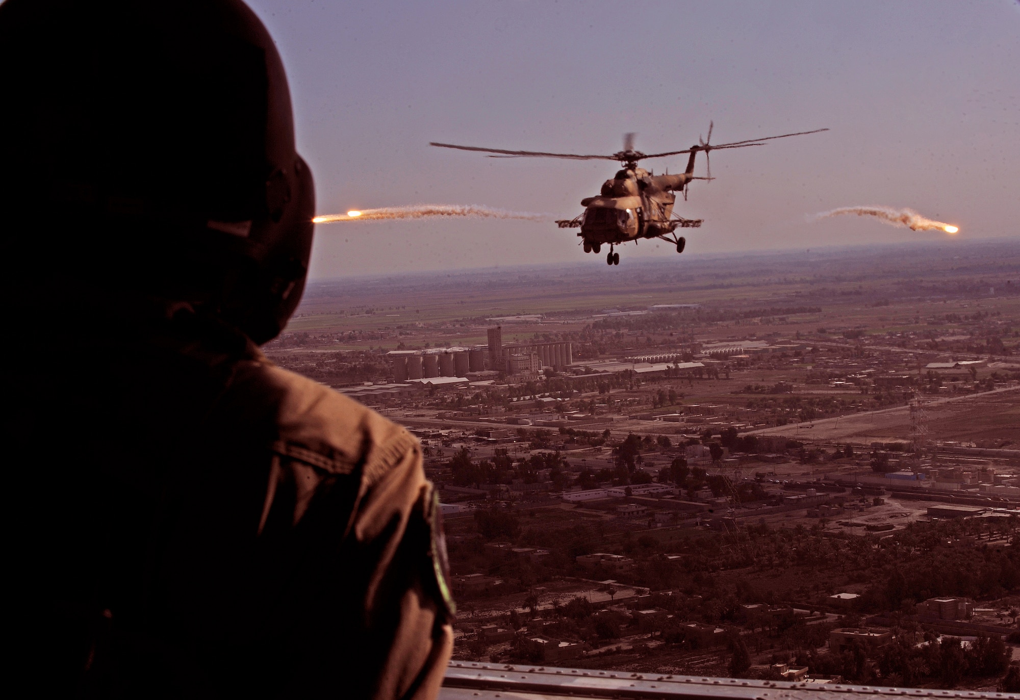 CAMP TAJI, Iraq -- An Iraqi Army Aviation Command Mi-171 multi-mission helicopter releases flares as it returns to base after conducting troop insertion training at a forward operating base near Baghdad International Airport March 2. U.S. Air Force pilots and aerial gunners assigned to Iraq Training and Advisory Mission - Air conducted training with their Iraqi partners to improve their proficiency on various tactics, techniques and procedures. (U.S. Air Force/Tech. Sgt. Jason Lake)