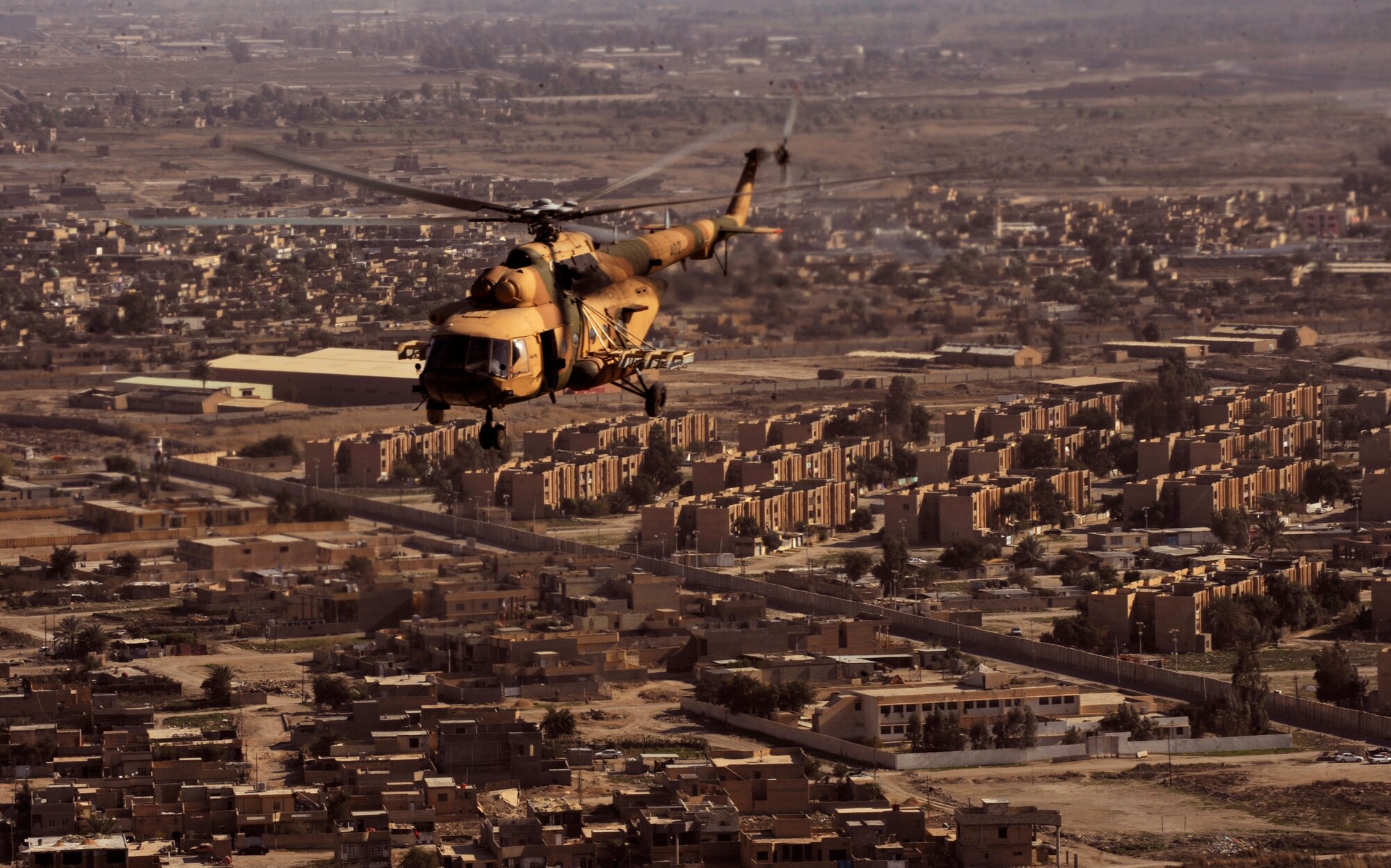 CAMP TAJI, Iraq -- An Iraqi Army Aviation Command Mi-171 multi-mission helicopter flown by an Iraqi pilot and Capt. Bill Root, a U.S. Air Force advisor co-pilot, return to base after conducting troop insertion training at a forward operating base near Baghdad International Airport March 2. U.S. Air Force pilots and aerial gunners assigned to Iraq Training and Advisory Mission - Air conducted training with their Iraqi partners to improve their proficiency on various tactics, techniques and procedures. (U.S. Air Force/Tech. Sgt. Jason Lake)