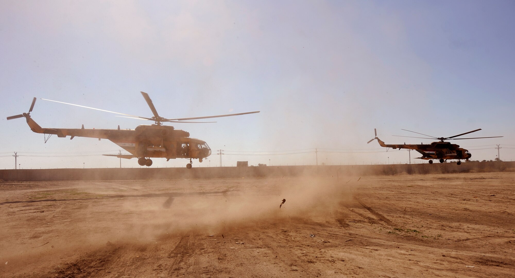 CAMP TAJI, Iraq -- A pair of Iraqi Army Aviation Command Mi-171 multi-mission helicopters conduct troop insertion training at a forward operating base near Baghdad International Airport March 2. U.S. Air Force pilots and aerial gunners assigned to Iraq Training and Advisory Mission - Air conducted training with their Iraqi partners to improve their proficiency on various tactics, techniques and procedures. (U.S. Air Force/Tech. Sgt. Jason Lake)