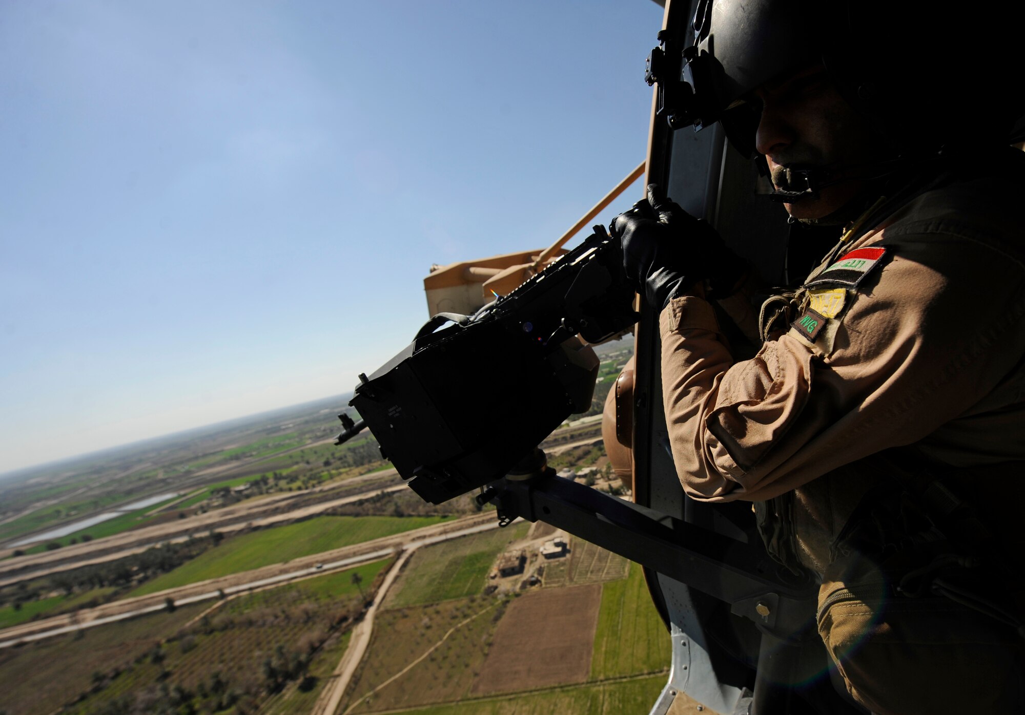 CAMP TAJI, Iraq -- An Iraqi Army Aviation Command aerial gunner prepares to test fire his M-240 machine gun on the weapons range as U.S. Air Force and Iraqi air force aircrews train together on an Mi-171 multi-mission helicopter March 2. Iraq Training and Advisory Mission - Air advisors worked with their Iraqi partners conducting troop insertion training at a forward operating base near Baghdad International Airport. (U.S. Air Force/Tech. Sgt. Jason Lake)