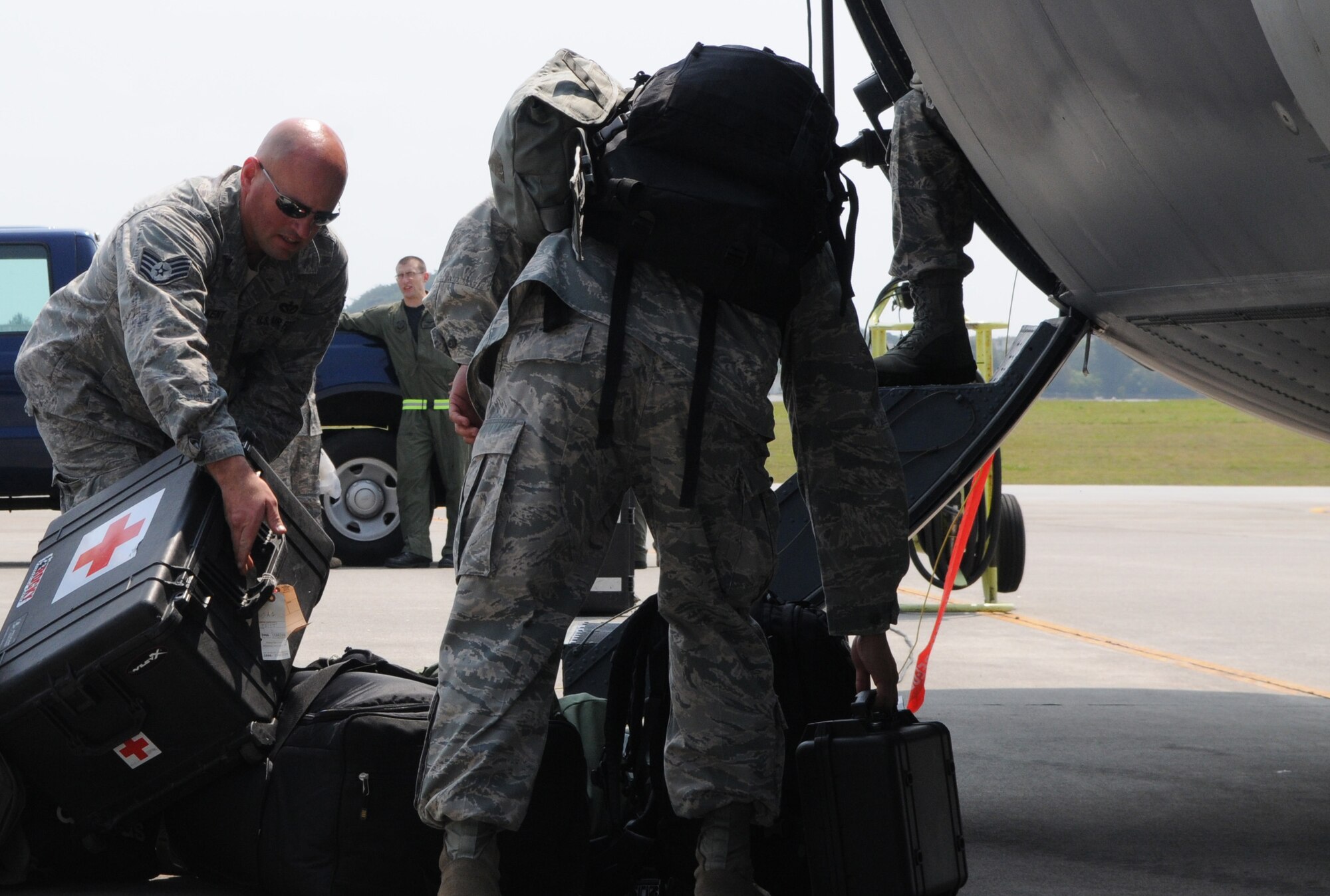 KADENA AIR BASE, Japan -- Airmen from the 353rd Special Operations Group load medical supplies and personal bags into a MC-130H Combat Talon II here March 14. The aircraft is delivering additional equipment and support forces for the 353rd Special Operations Group forces deployed supporting humanitarian relief efforts at Yokota Air Base. (U.S. Air Force photo by Tech. Sgt. Aaron Cram)