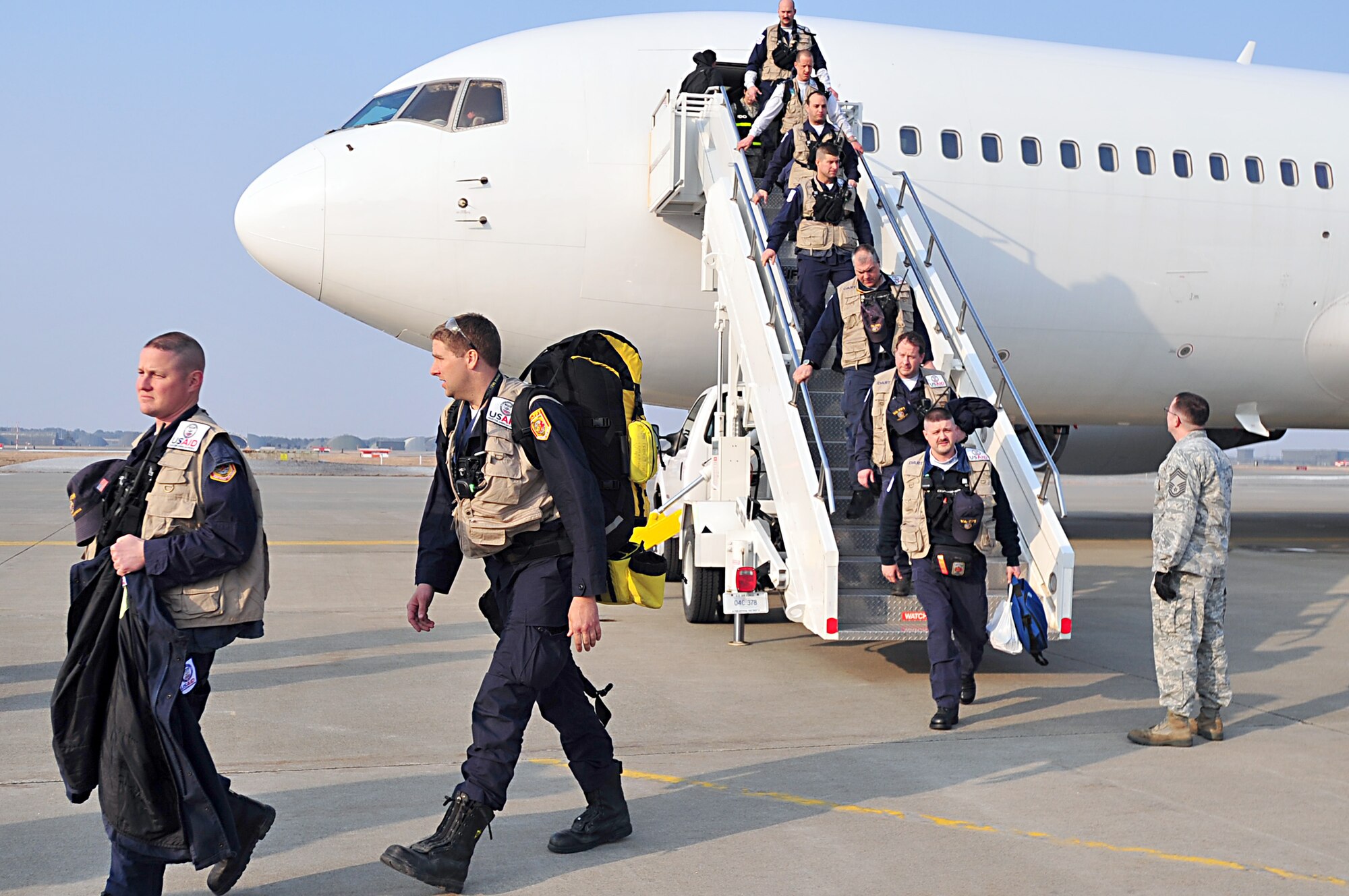 MISAWA AIR BASE, Japan -- United States Agency for International Development workers from the Los Angeles County Fire Department, Calif. and Fairfax County, Va. Urban Search and Rescue, arrive Mar. 13. The teams arrived in support of Operation Tomodachi after a 9.1 magnitude earthquake hit 100 miles off the coast of Northern Japan Mar. 11. (U.S. Air Force photo by Staff Sgt. Marie Brown\Released)
