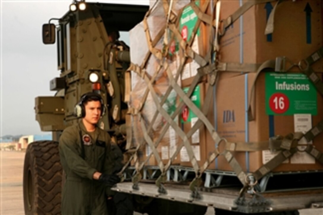 U.S. Marine Corps Cpl. Brandon Lopez helps load a palette of medical supplies into a KC-130J Super Hercules aircraft to provide assistance in the wake of the earthquake and tsunami that struck Japan at Marine Corps Air Station Futenma, Okinawa, on March 12, 2011.  Lopez, a crew chief, is assigned to Marine Aerial Refueler Transport Squadron 152, Marine Aircraft Group 36, 1st Marine Aircraft Wing, III Marine Expeditionary Force.  