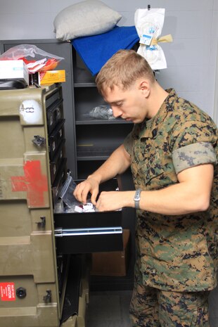 Seaman Daniel E. Truelove, Marine All-Weather Fighter::r::::n::Attack Squadron 533 aviation medicine technician, performs a routine medicine inventory during exercise::r::::n::Cope Tiger here March 15.