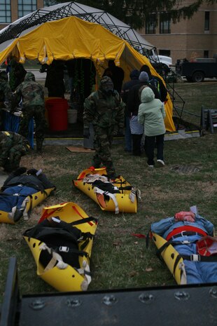 MUSCATATUCK URBAN TRAINING CENTER, Ind. - Decontamination Marines from Initial Response Forces B, Chemical Biological Incident Response Force, run the ambulatory and non-ambulatory decontamination lines during a 12-hour training exercise at the training operation Vibrant Response 1.1.  The Marines and sailors of CBIRF drove from their base, Naval Support Facility Indian Head, in Maryland to Indiana and transitioned straight into a 24-hour training operation. (Photo by Sgt. Frances L. Goch)(Released)