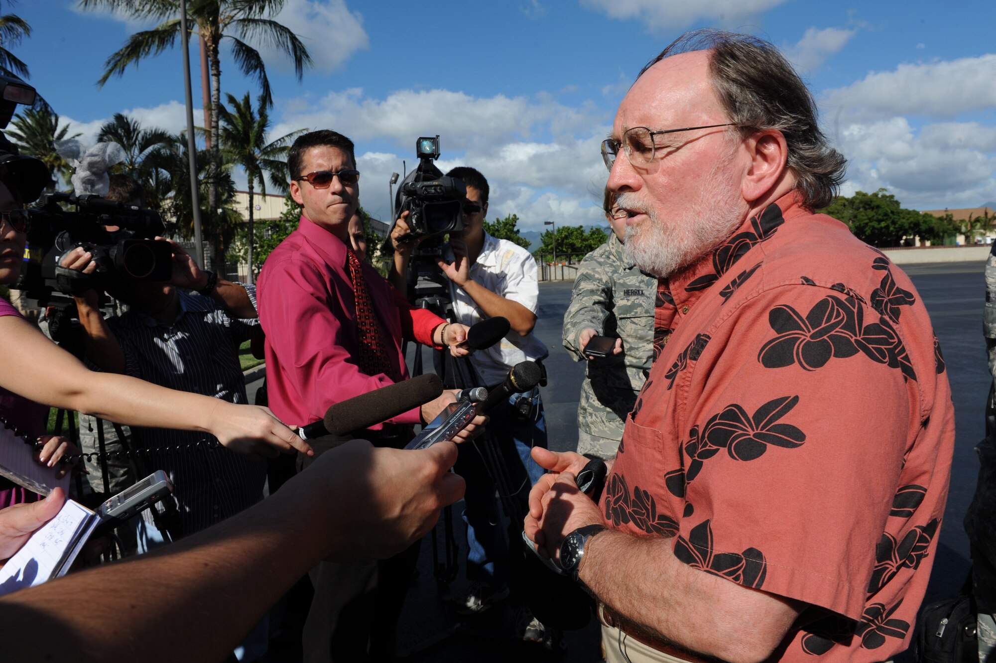 Hawaii State Governor Neil Abercrombie speaks to local media on the 15th Wing flight line at Joint Base Pearl Harbor-Hickam, Hawaii, March 15. Governor Abercrombie flew over the Hawaiian Islands with the Adjutant General, U.S. Air Force Maj. Gen. Darryll D.M. Wong; the Director of Land and Natural Resources, Mr. William Aila; and the Hawaii National Guard's Joint Chief of Staff, Army Col. Joe Logan, to conduct damage assessment after a tsunami hit the islands March 11. They flew in a Hawaii Army National Guard aircraft and landed on the U.S. Air Force flight line. (U.S. Air Force photo/Airman 1st Class Lauren Main)