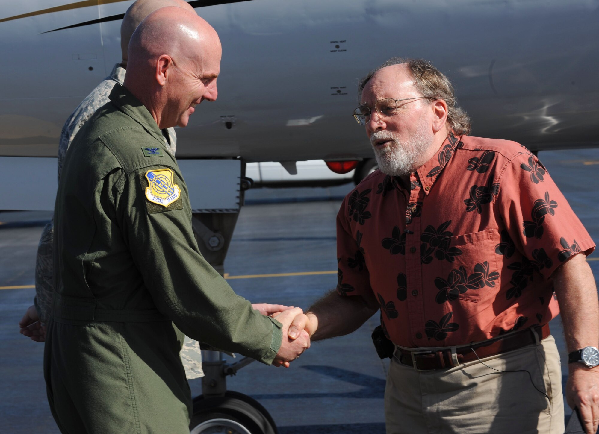 U.S. Air Force 15th Wing Commander Col. Sam Barrett, left, greets Hawaii State Governor Neil Abercrombie at Joint Base Pearl Harbor-Hickam, Hawaii, March 15. Governor Abercrombie flew over the Hawaiian Islands with the Adjutant General, U.S. Air Force Maj. Gen. Darryll D.M. Wong; the Director of Land and Natural Resources, Mr. William Aila; and the Hawaii National Guard's Joint Chief of Staff, Army Col. Joe Logan, to conduct damage assessment after a tsunami hit the islands March 11. They flew in a Hawaii Army National Guard aircraft and landed on the U.S. Air Force flight line. (U.S. Air Force photo/Airman 1st Class Lauren Main)
