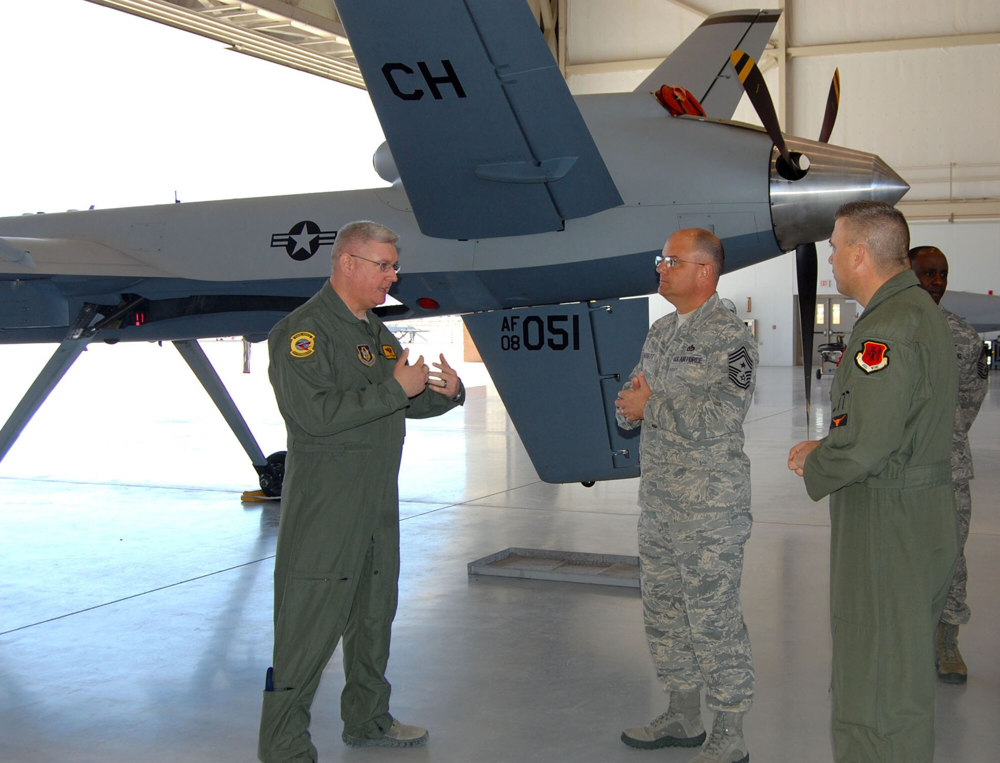 CREECH AIR FORCE BASE, Nev. - Members of the 78th Reconnaissance Squadron provide Chief Master Sergeant Dwight Badgett, Air Force Reserve Command Chief (center), with a walkaround tour of the MQ-9 Reaper unmanned aircraft March 4. Chief Badgett visited the unit to learn about its Total Force Integration with the Regular Air Force. (U.S. Air Force photo/Capt. Jessica Martin)