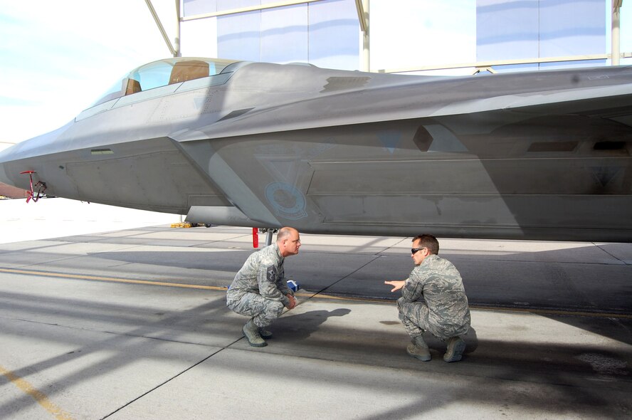 NELLIS AIR FORCE BASE, Nev. - Tech. Sgt. Donovan Williams, 926th Aircraft Maintenance Squadron (right), explains the intricacies of an F-22 Raptor to Chief Master Sgt. Dwight Badgett, Air Force Reserve Command Chief, during his visit to the 926th Group on March 6. Sergeant Williams is a reservist integrated into the 57th Maintenance Group here. (U.S. Air Force photo/Capt. Jessica Martin)