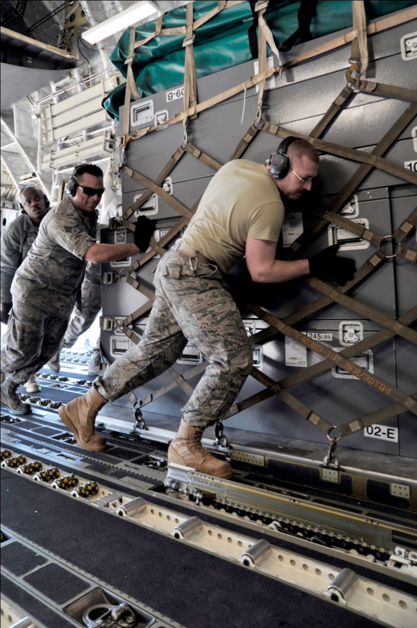 Airmen from the 89th Aerial Port Squadron load pallets onto a C-17 Globemaster III on March 12, 2011, at Joint Base Andrews, Md. Air transportation Airmen from the 89th APS created 14 pallets of technical search and rescue gear, to include inflatable swift-water rescue boats, generators, trench rescue and cutting equipment. The gear is being transported by C-17 to more than 80 Fairfax County Urban Search and Rescue technicians, to provide assistance in the rescue effort after an earthquake and tsunami hit Japan on March 11, 2011. (U.S. Air Force Photo/Senior Airman Perry Aston) 