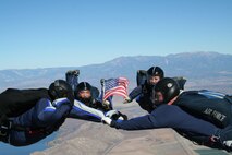 Tech. Sgt. Randall Sole, aircrew flight equipment technician with the 535th Airlift Squadron, (right) salutes Capt. Anthony Marapain, UV18 pilot and instructor at the U.S. Air Force Academy, (left) during Sergeant Sole's unorthodox reenlistment ceremony Nov. 20, 2009. Sergeant Sole was assigned to USAFA as an instructor for the USAFA competitive jump team, "Wings of Blue". (U.S. Air Force photo/ Master Sgt. Justus Hanks)